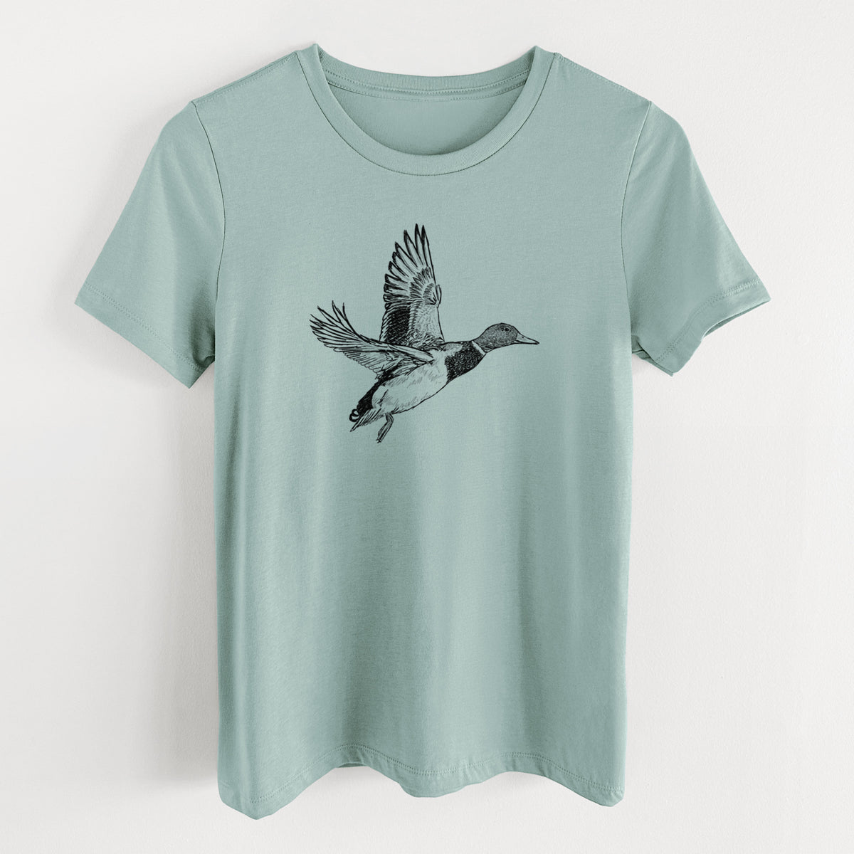 Dusty blue women's relaxed fit cotton t-shirt laid flat, printed with a detailed black ink illustration of a male mallard duck taking flight.