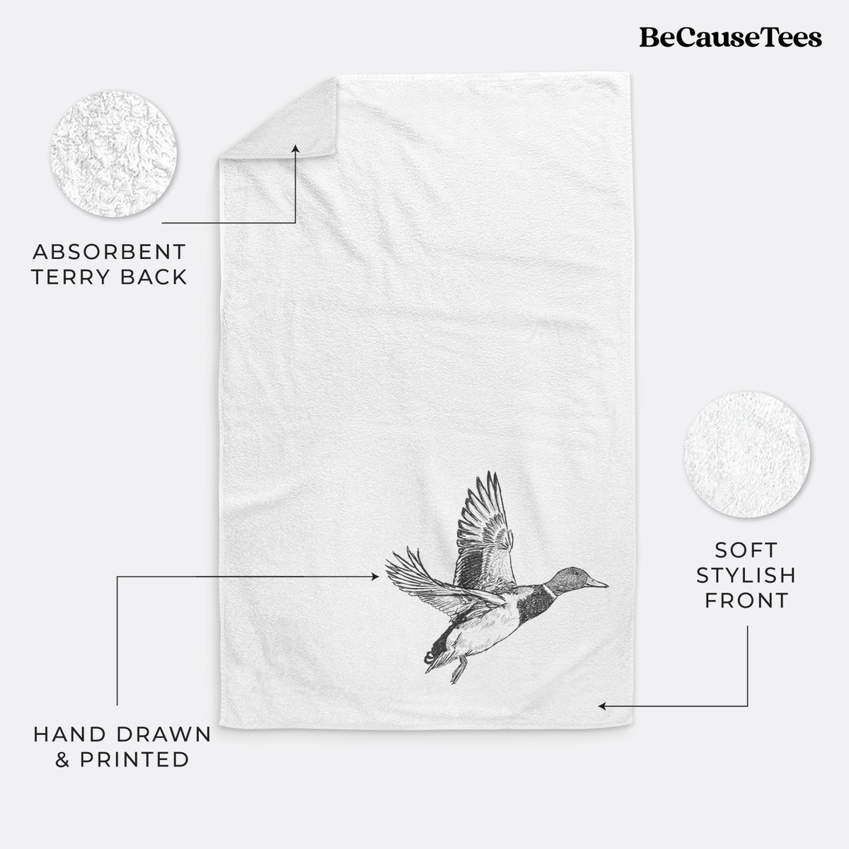 White hand towel printed with a detailed black ink illustration of a male mallard duck taking flight.