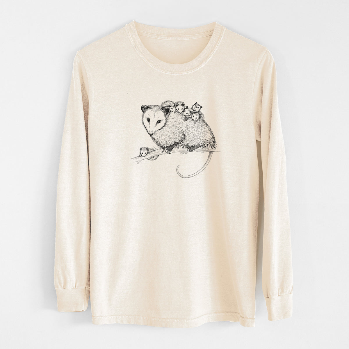Ivory Comfort Colors long sleeve shirt laid flat, printed with a black ink illustration of a mother opossum on a branch carrying her babies on her back.