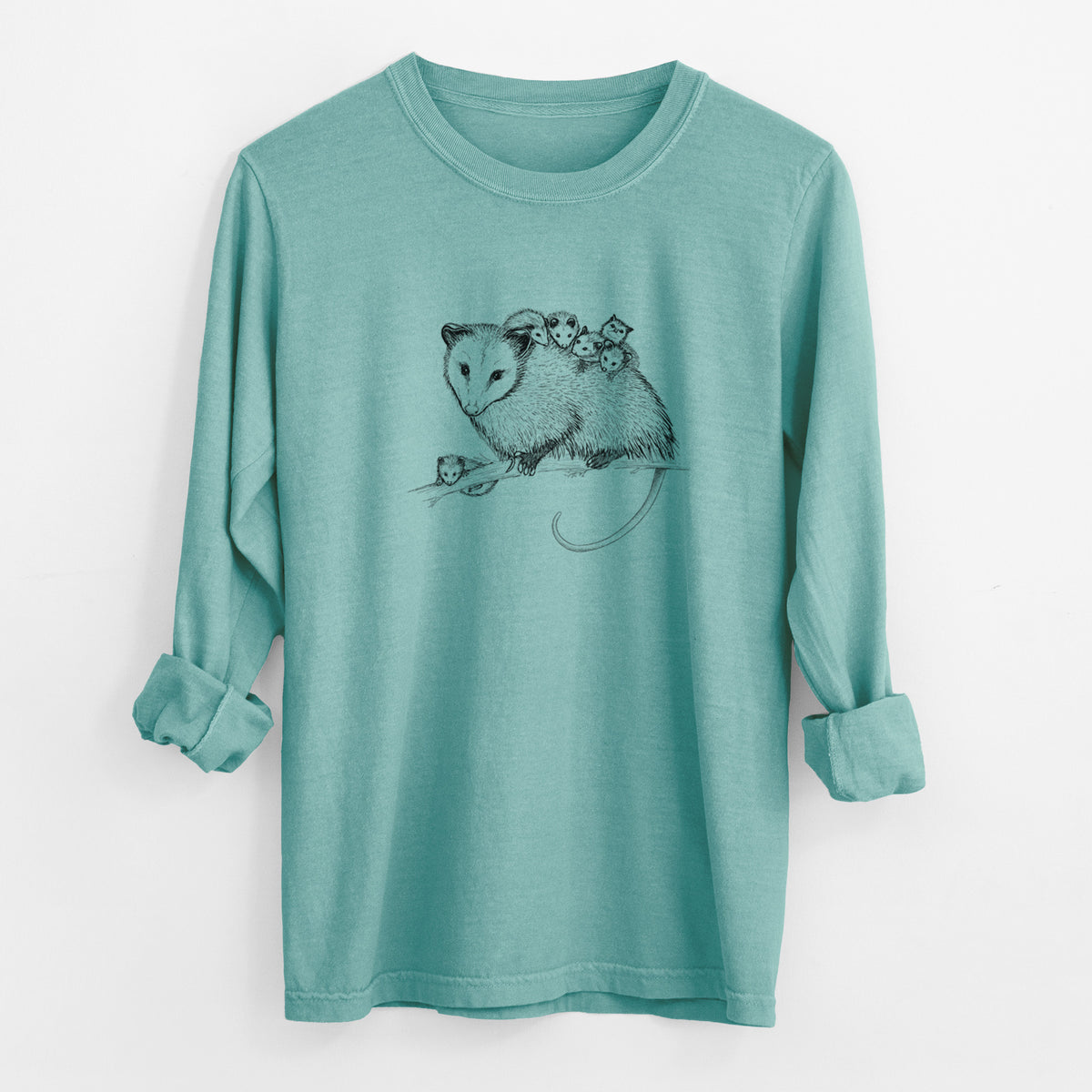 Reef green Comfort Colors long sleeve shirt laid flat with the cuffs rolled, printed with a black ink illustration of a mother opossum on a branch carrying her babies on her back.