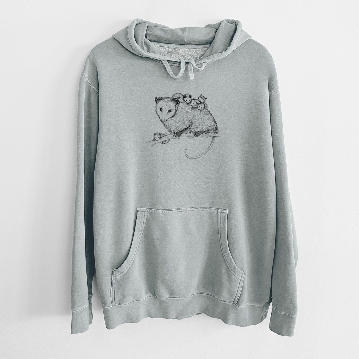 Sage green pigment dyed hoodie laid flat, printed with a black ink illustration of a mother opossum on a branch carrying her babies on her back.