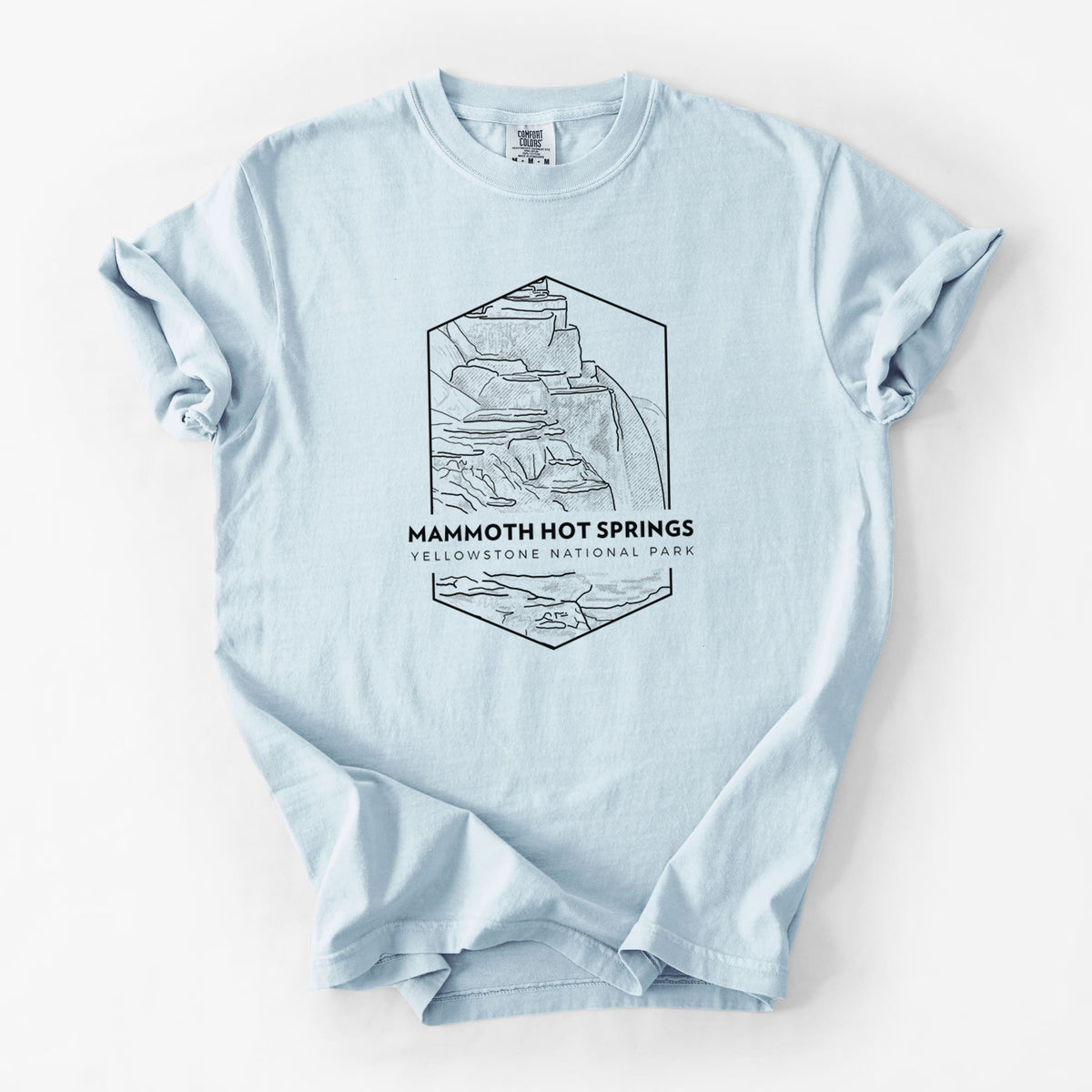 Chambray blue Comfort Colors t-shirt laid flat, printed with a black line art badge of the terraces at Mammoth Hot Springs, with the words Mammoth Hot Springs, Yellowstone National Park.
