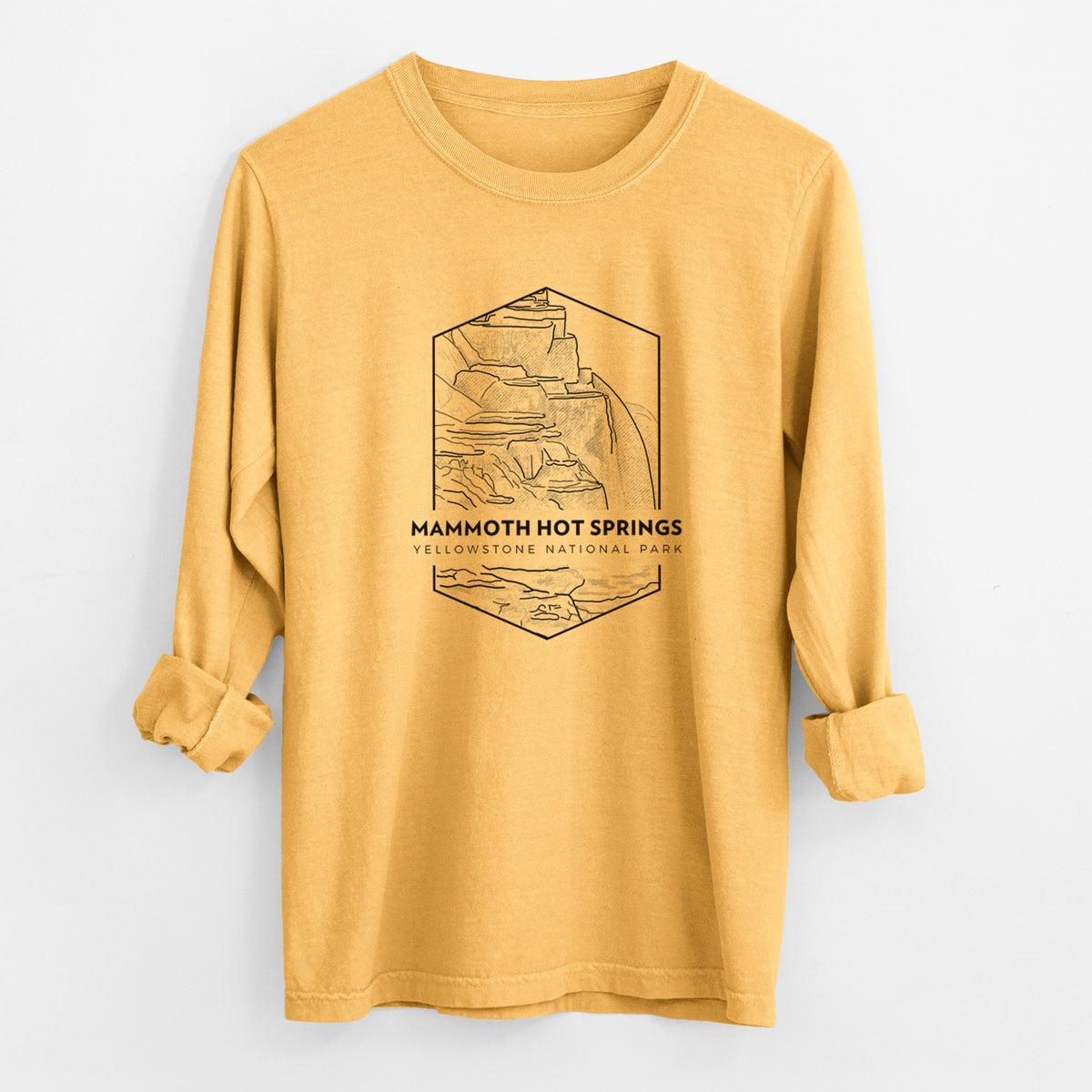 Golden wheat yellow Comfort Colors long sleeve shirt laid flat with the cuffs rolled, printed with a black line art badge of the terraces at Mammoth Hot Springs, with the words Mammoth Hot Springs, Yellowstone National Park.