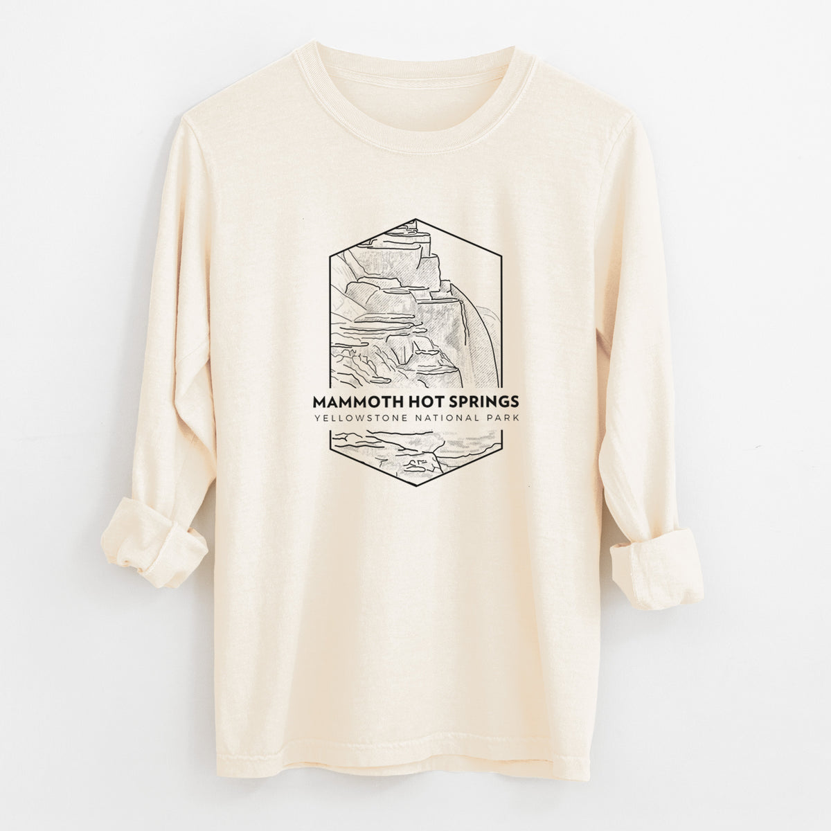 Ivory Comfort Colors long sleeve shirt laid flat with the cuffs rolled, printed with a black line art badge of the terraces at Mammoth Hot Springs, with the words Mammoth Hot Springs, Yellowstone National Park.