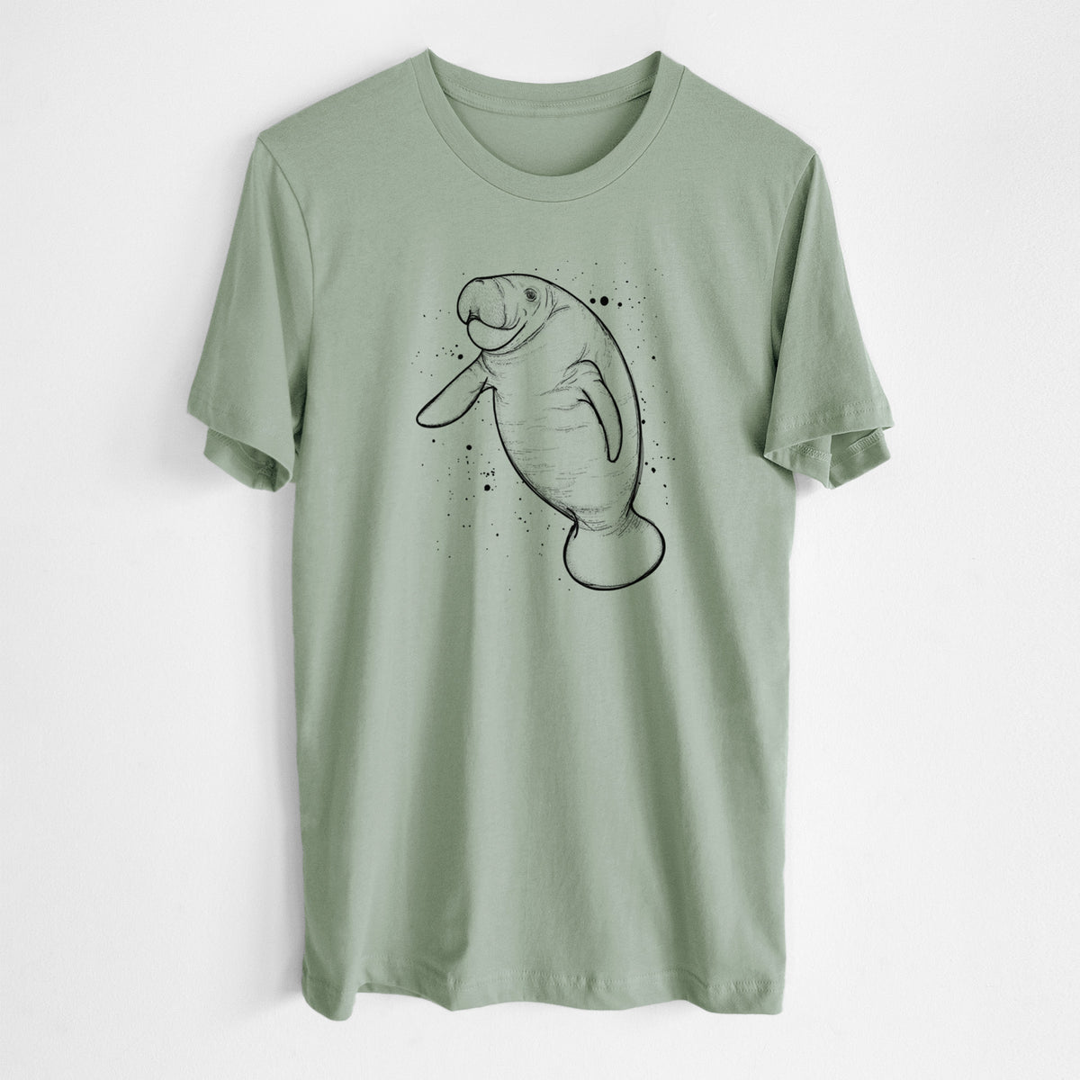 Sage green lightweight cotton t-shirt laid flat, printed with a black ink line drawing of a manatee swimming, with ink splatters.