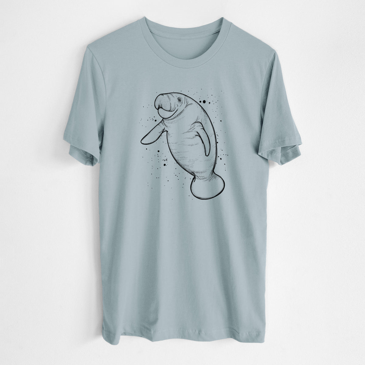 Vintage denim lightweight cotton t-shirt laid flat, printed with a black ink line drawing of a manatee swimming, with ink splatters.