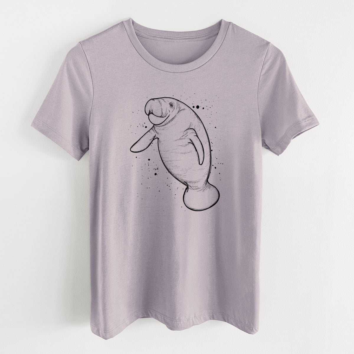 Light violet women's relaxed fit cotton t-shirt laid flat, printed with a black ink line drawing of a manatee swimming, with ink splatters.