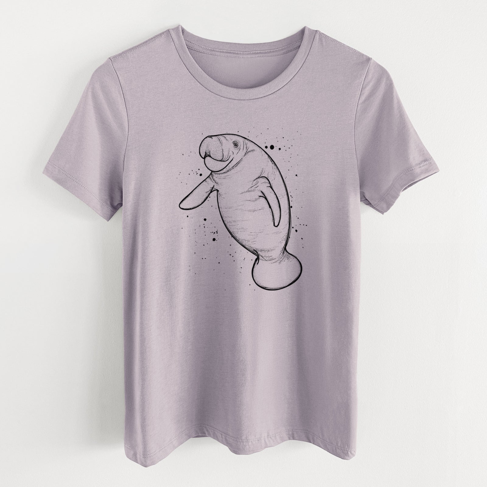Light violet women's relaxed fit cotton t-shirt laid flat, printed with a black ink line drawing of a manatee swimming, with ink splatters.