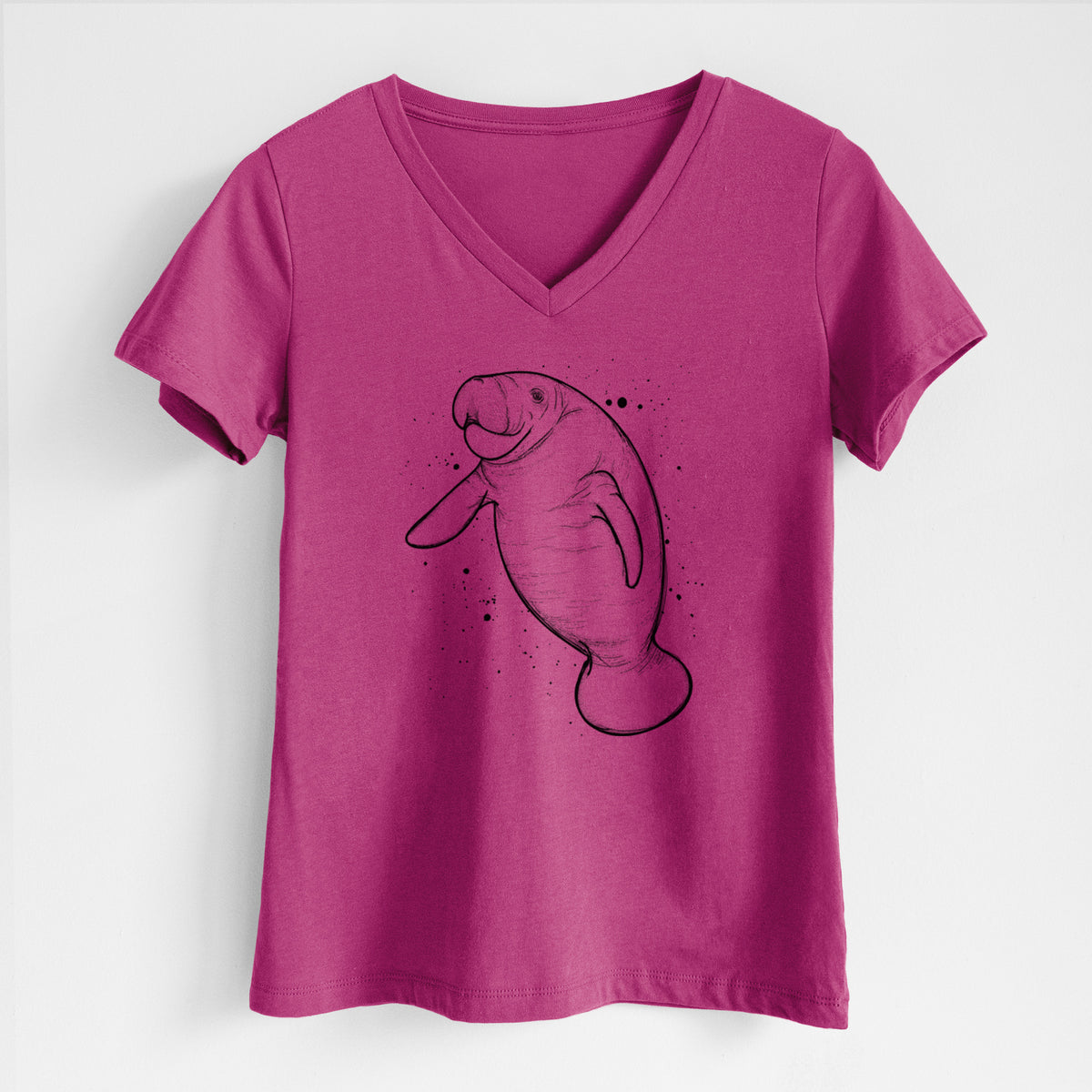 Berry pink women's relaxed fit cotton V-neck t-shirt laid flat, printed with a black ink line drawing of a manatee swimming, with ink splatters.