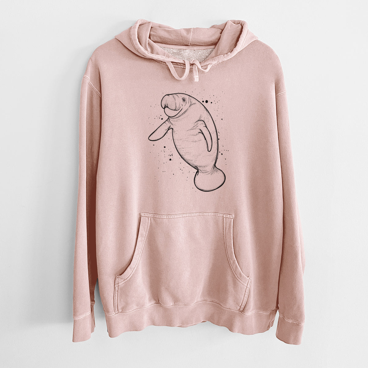 Dusty pink pigment dyed hoodie laid flat, printed with a black ink line drawing of a manatee swimming, with ink splatters.