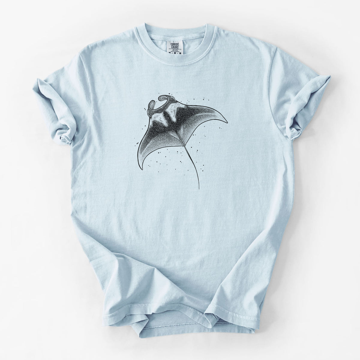 Chambray blue Comfort Colors t-shirt laid flat, printed with a black ink illustration of a manta ray gliding.