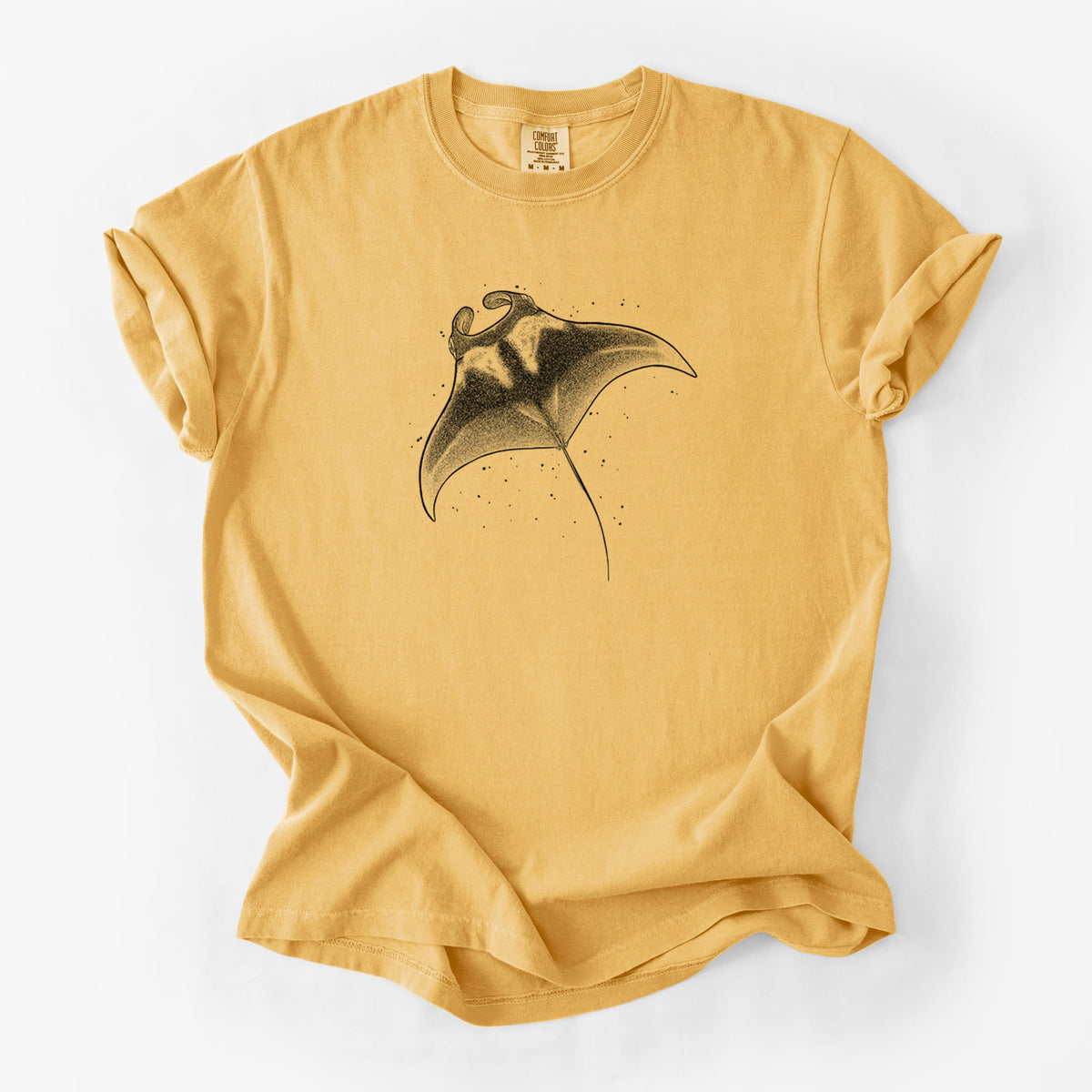 Golden wheat yellow Comfort Colors t-shirt laid flat, printed with a black ink illustration of a manta ray gliding.