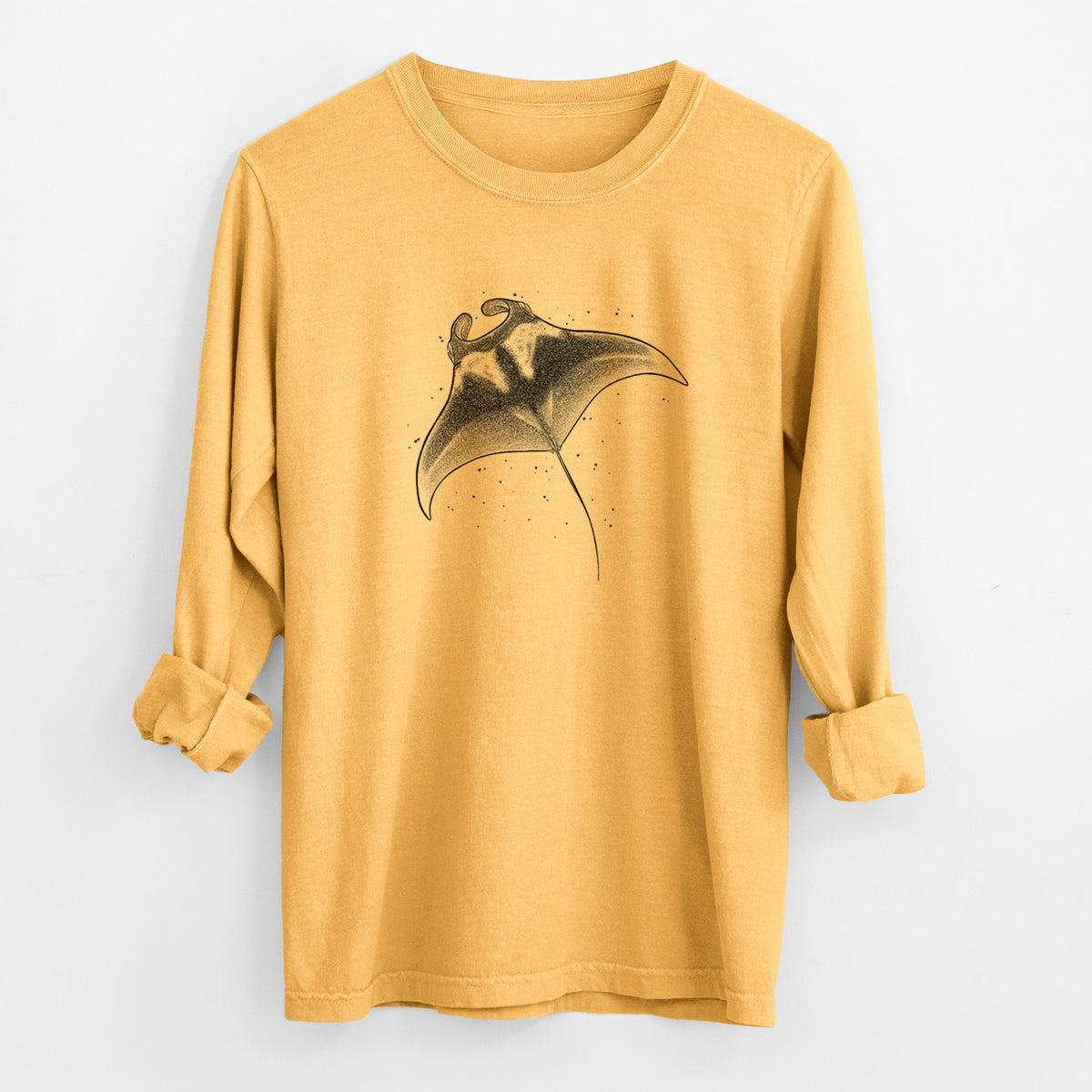 Golden wheat yellow Comfort Colors long sleeve shirt laid flat with the cuffs rolled, printed with a black ink illustration of a manta ray gliding.