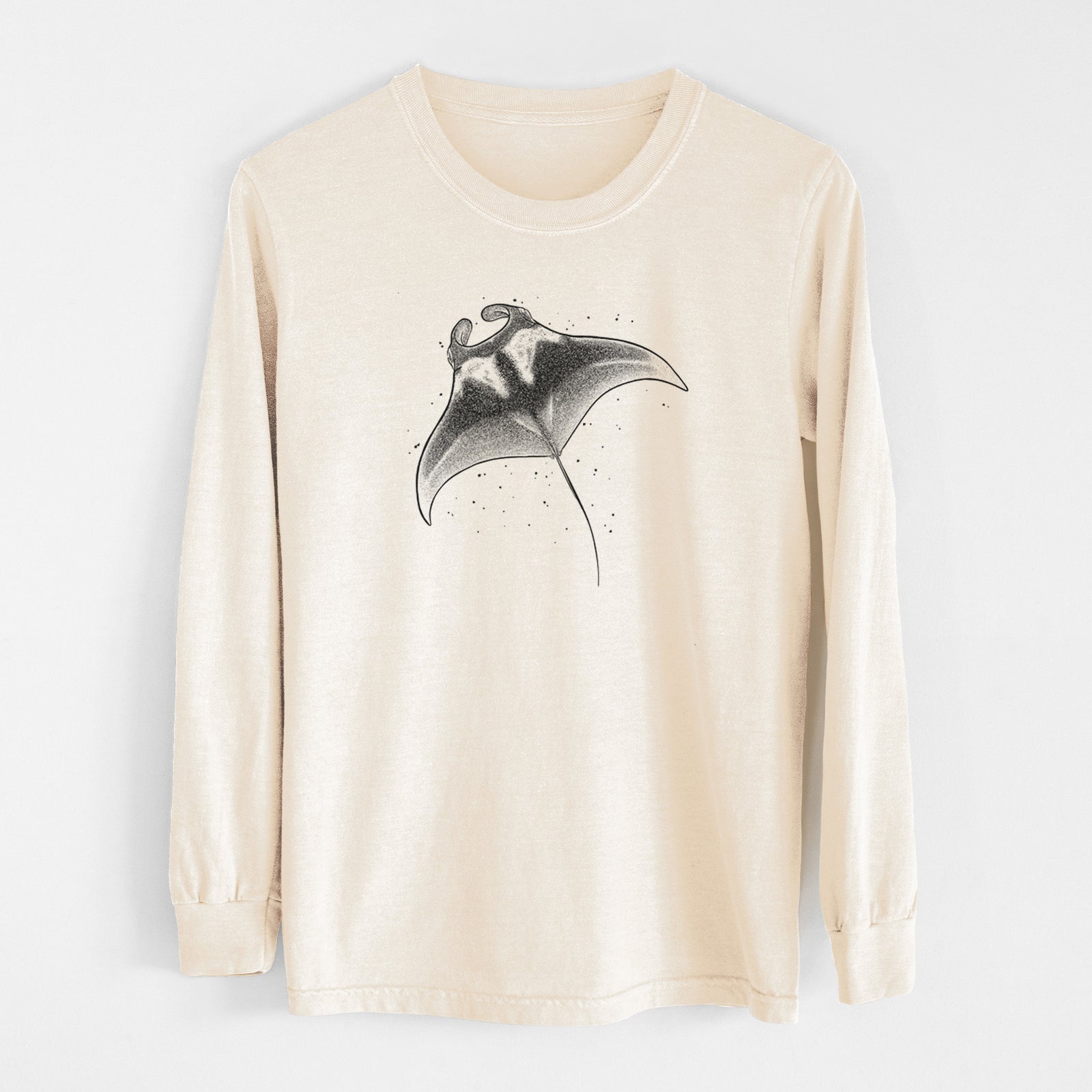 Ivory Comfort Colors long sleeve shirt laid flat, printed with a black ink illustration of a manta ray gliding.