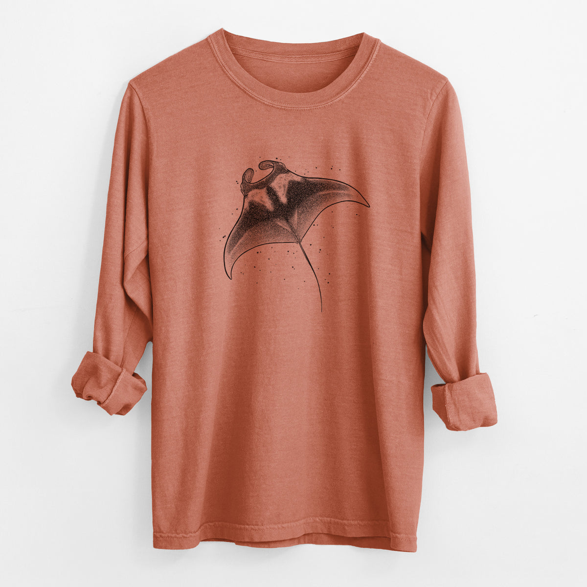 Yam burnt orange Comfort Colors long sleeve shirt laid flat with the cuffs rolled, printed with a black ink illustration of a manta ray gliding.