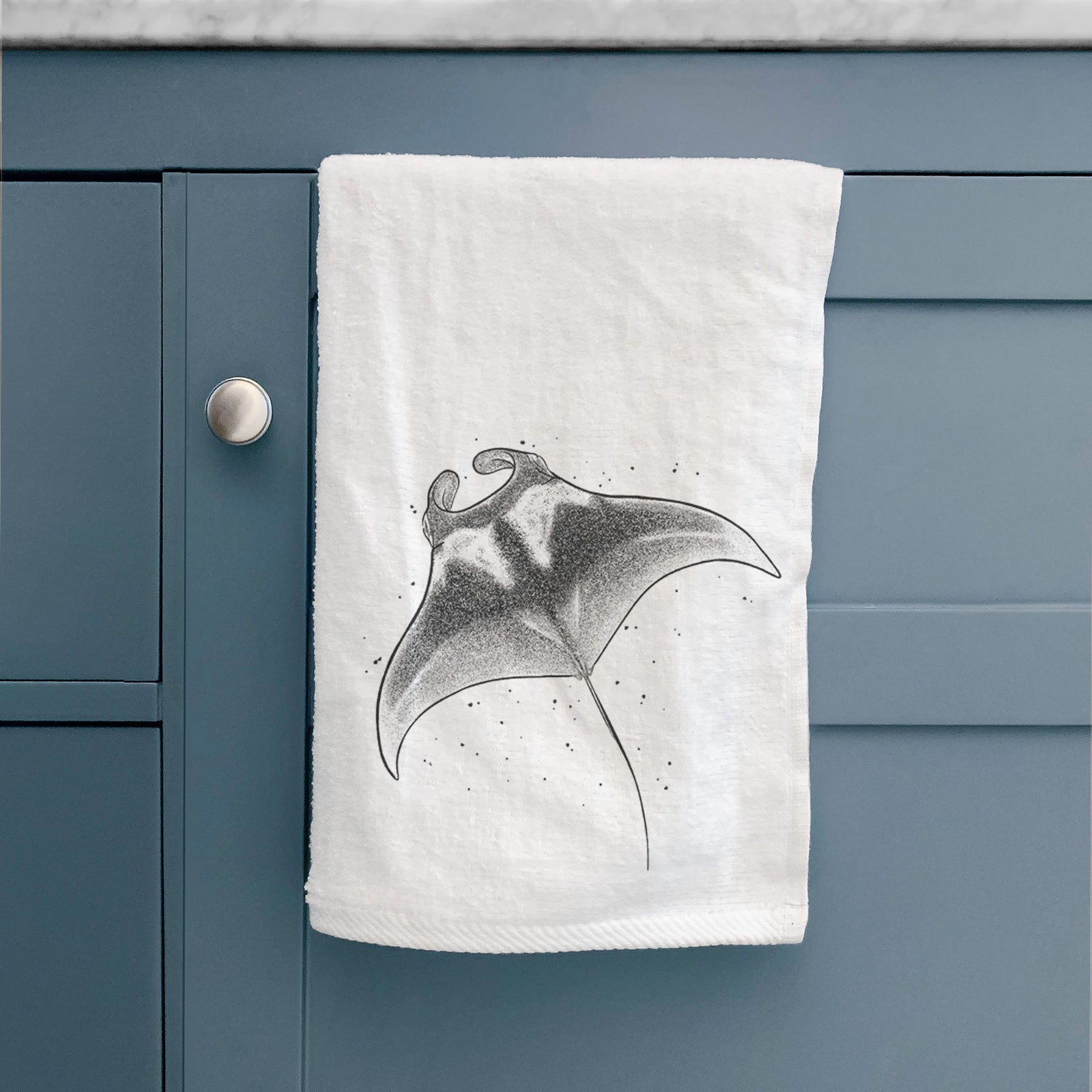 White hand towel printed with a black ink illustration of a manta ray gliding.