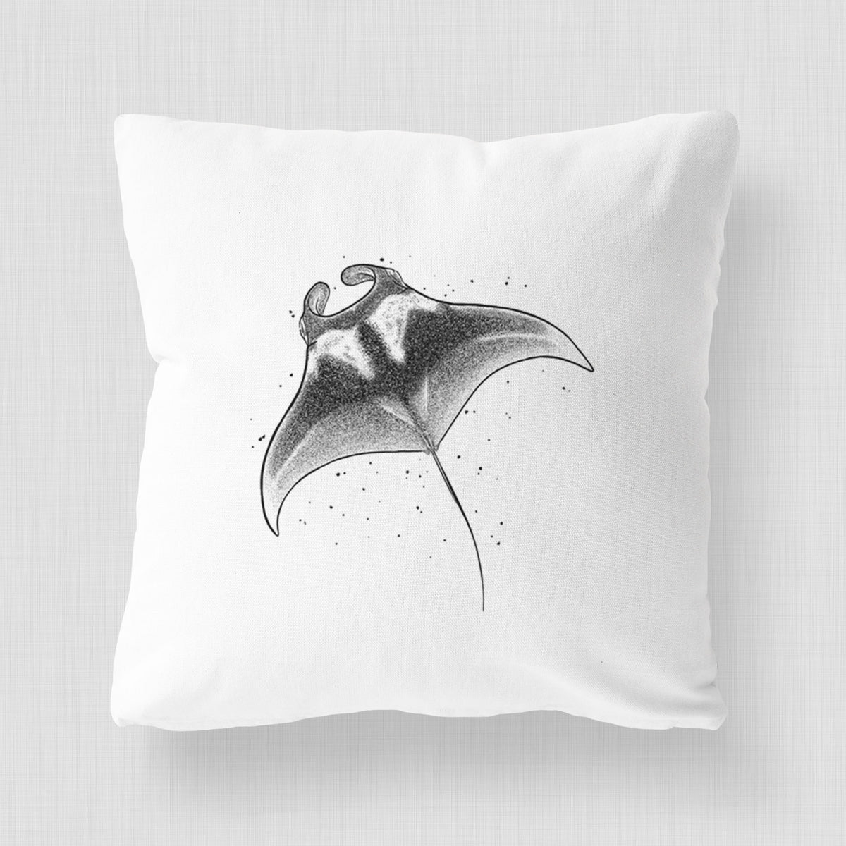White pillow cover printed with a black ink illustration of a manta ray gliding.