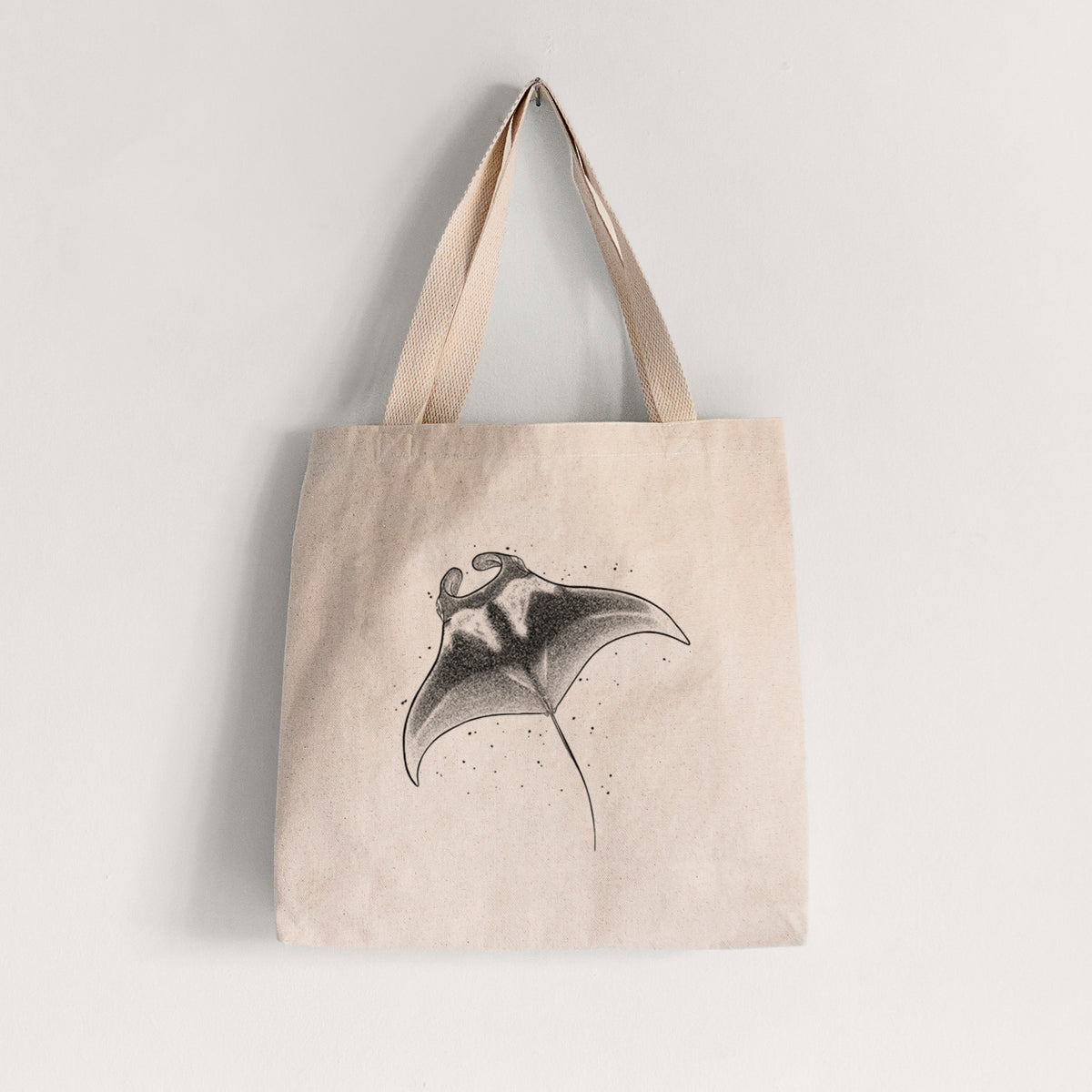 Natural canvas tote bag printed with a black ink illustration of a manta ray gliding.