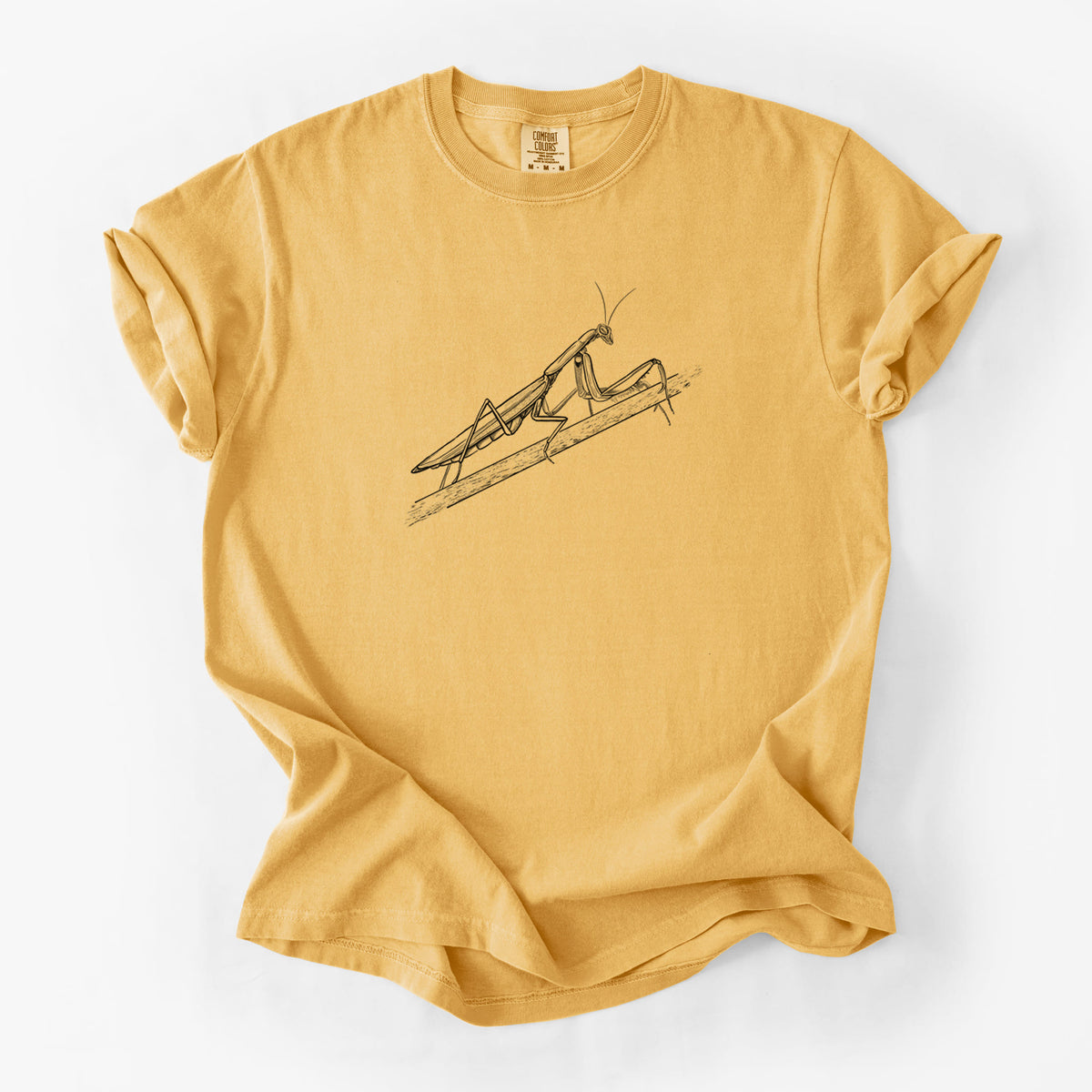 Golden wheat yellow Comfort Colors t-shirt laid flat, printed with a detailed black ink illustration of a praying mantis on a stem.