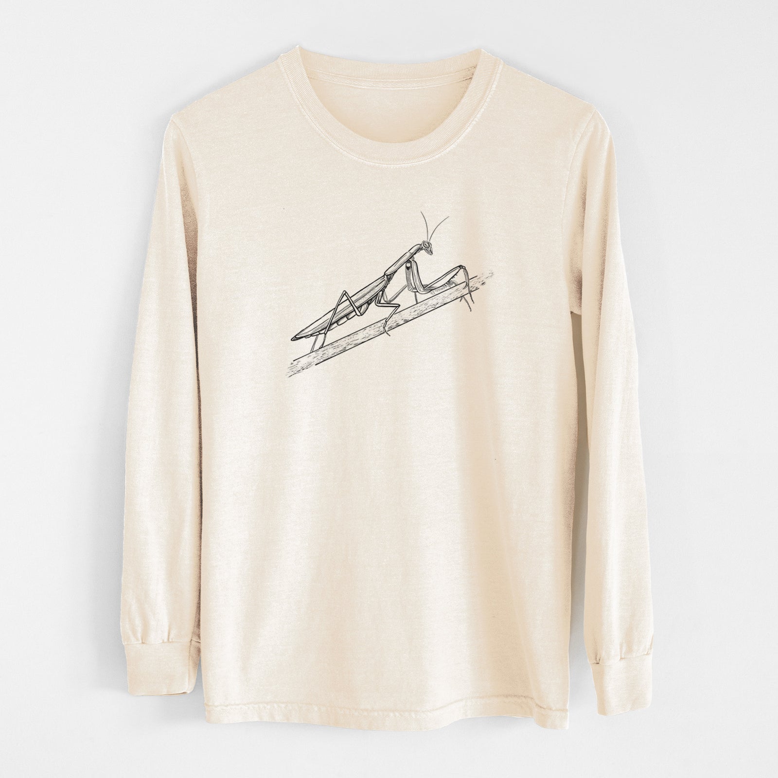 Ivory Comfort Colors long sleeve shirt laid flat, printed with a detailed black ink illustration of a praying mantis on a stem.