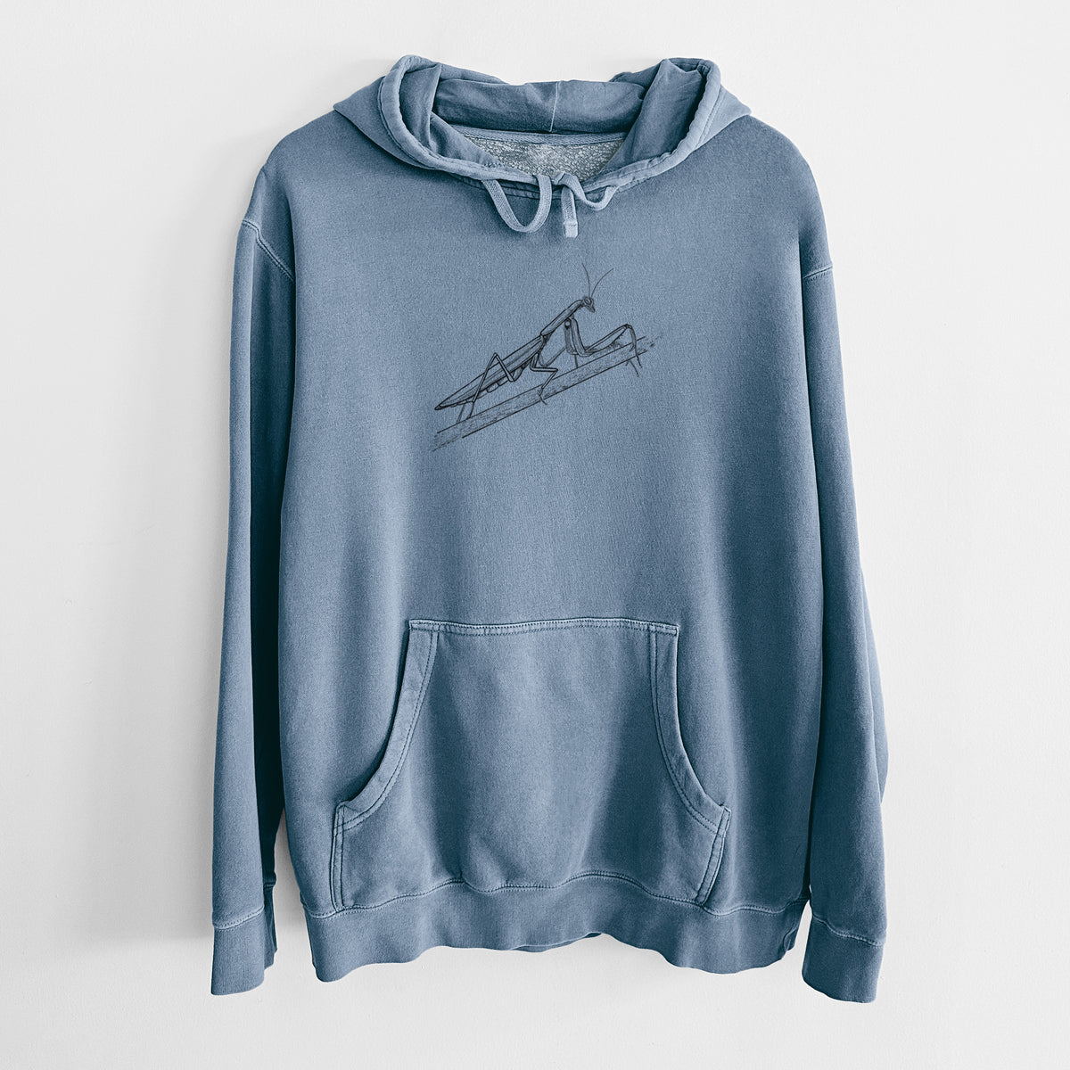 Slate blue pigment dyed hoodie laid flat, printed with a detailed black ink illustration of a praying mantis on a stem.