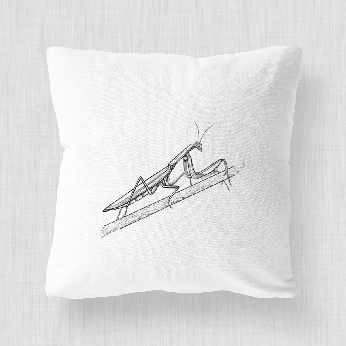 White pillow cover printed with a detailed black ink illustration of a praying mantis on a stem.