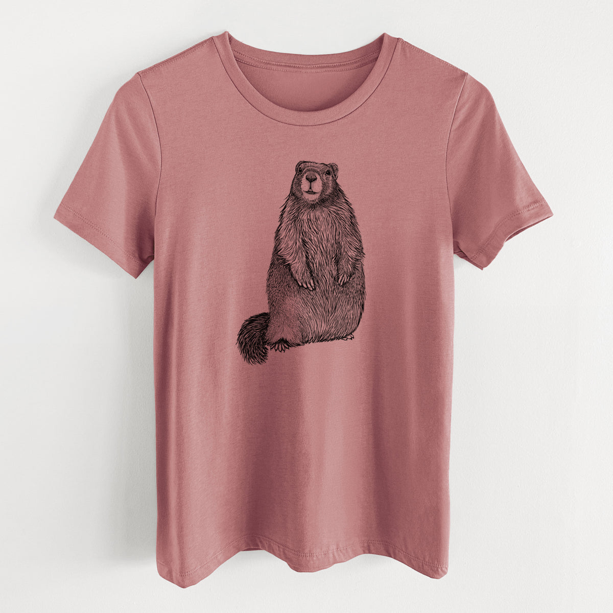 Mauve pink women's relaxed fit cotton t-shirt laid flat, printed with a detailed black ink illustration of a marmot standing upright.