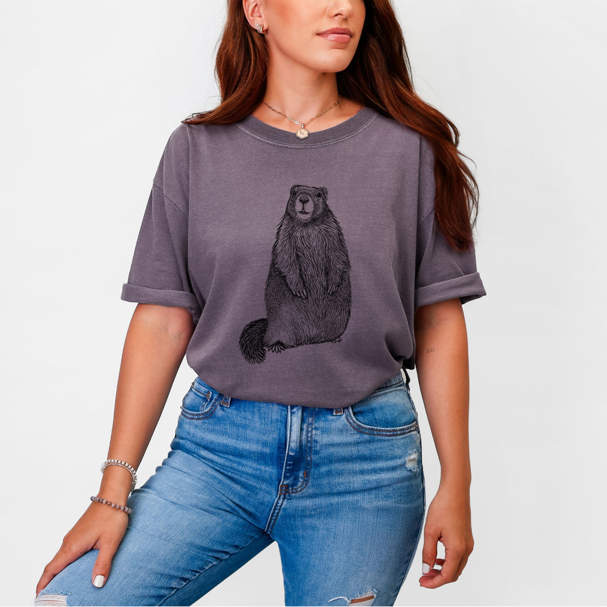 Woman wearing a Comfort Colors t-shirt printed with a detailed black ink illustration of a marmot standing upright.