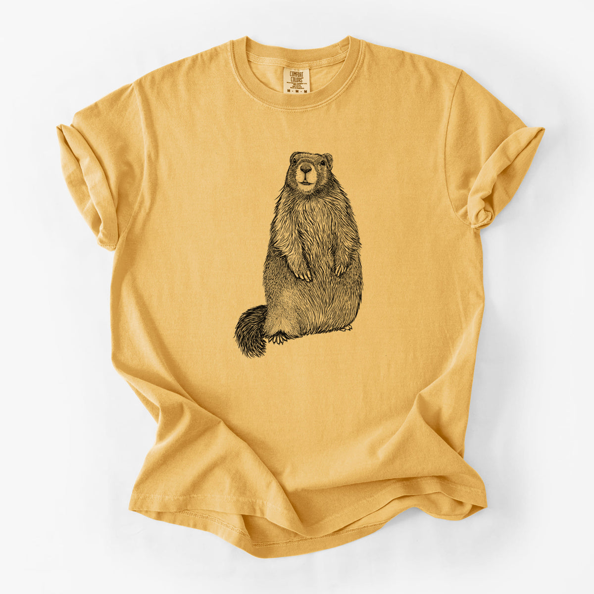 Golden wheat yellow Comfort Colors t-shirt laid flat, printed with a detailed black ink illustration of a marmot standing upright.