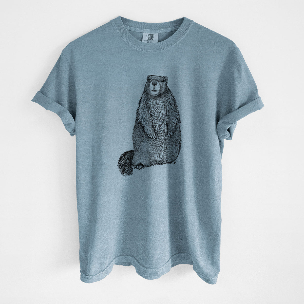 Steel blue Comfort Colors t-shirt laid flat, printed with a detailed black ink illustration of a marmot standing upright.