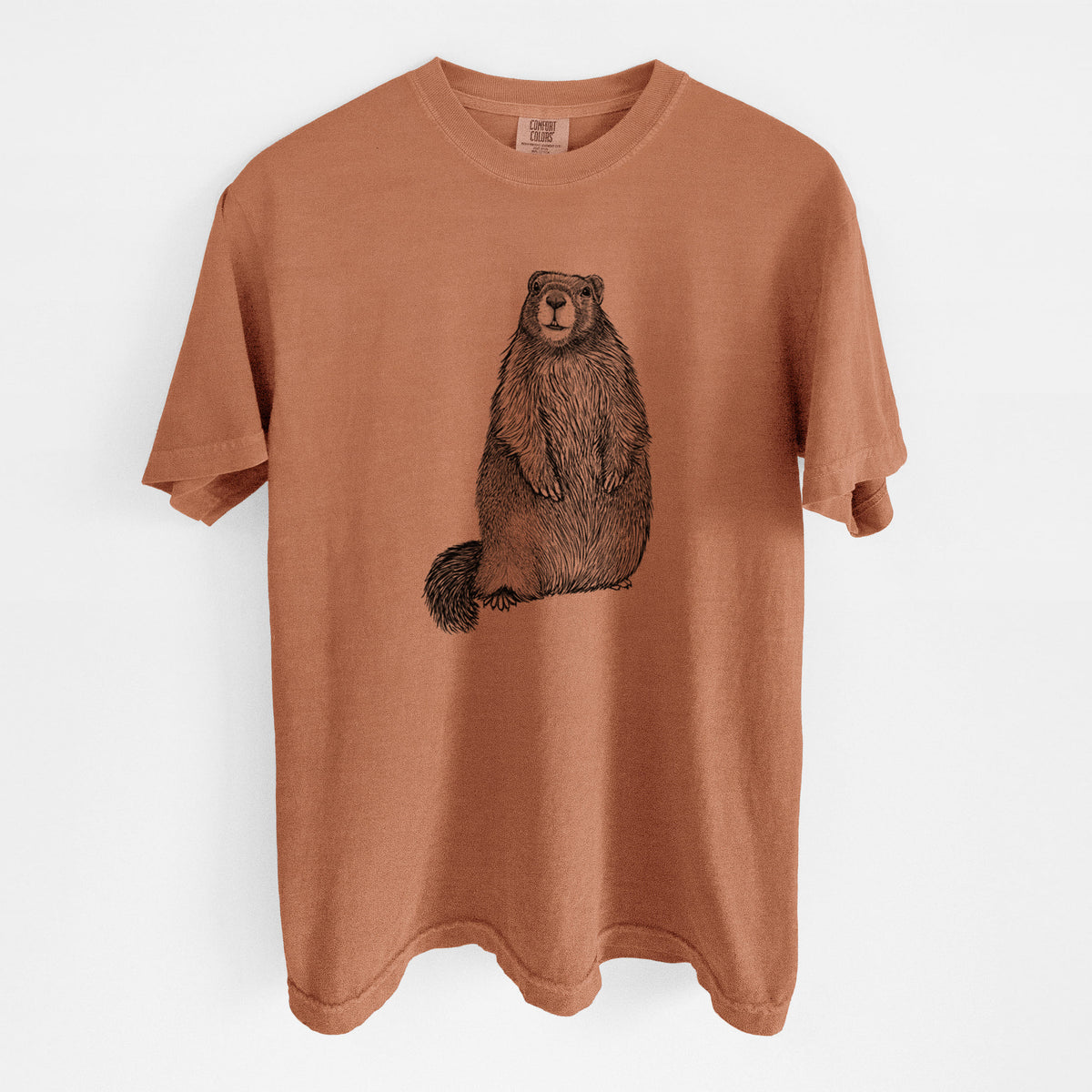 Yam burnt orange Comfort Colors t-shirt laid flat, printed with a detailed black ink illustration of a marmot standing upright.