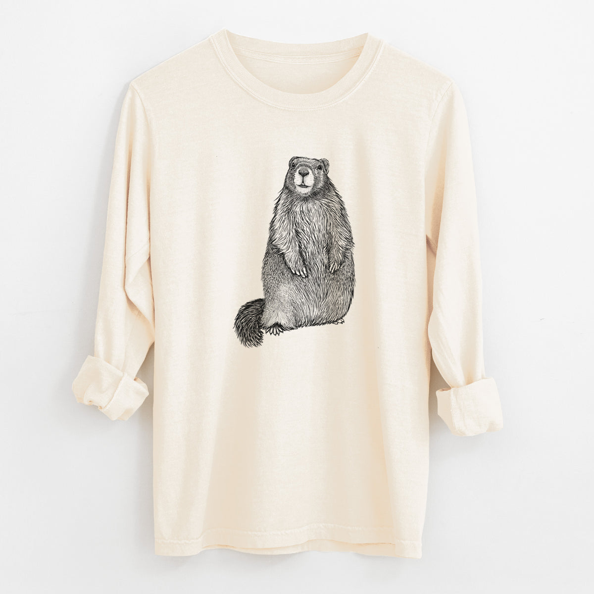 Ivory Comfort Colors long sleeve shirt laid flat with the cuffs rolled, printed with a detailed black ink illustration of a marmot standing upright.