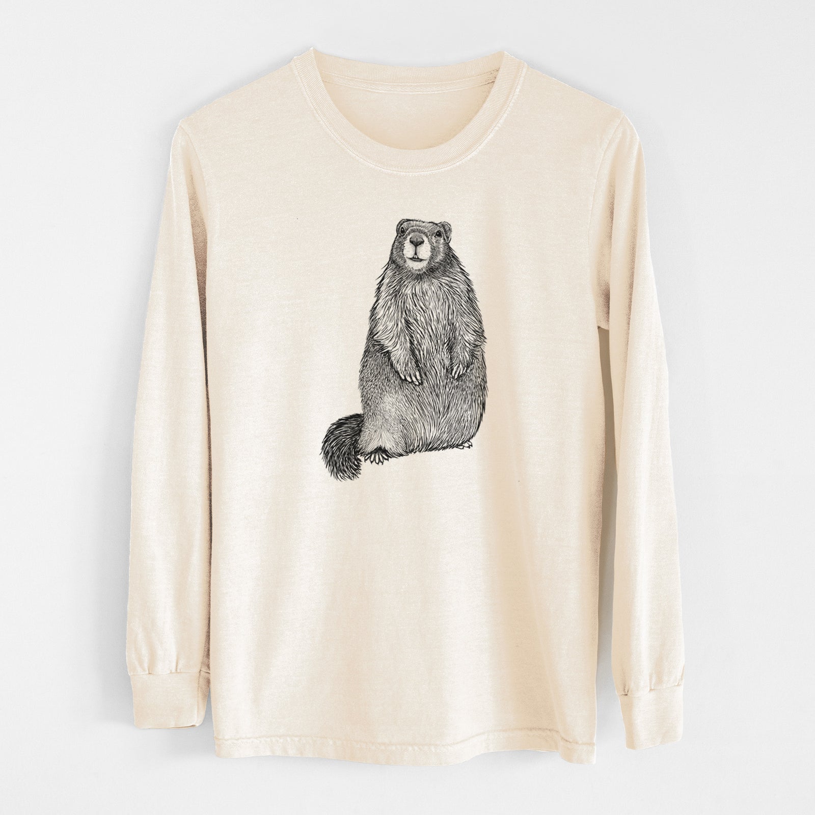 Ivory Comfort Colors long sleeve shirt laid flat, printed with a detailed black ink illustration of a marmot standing upright.