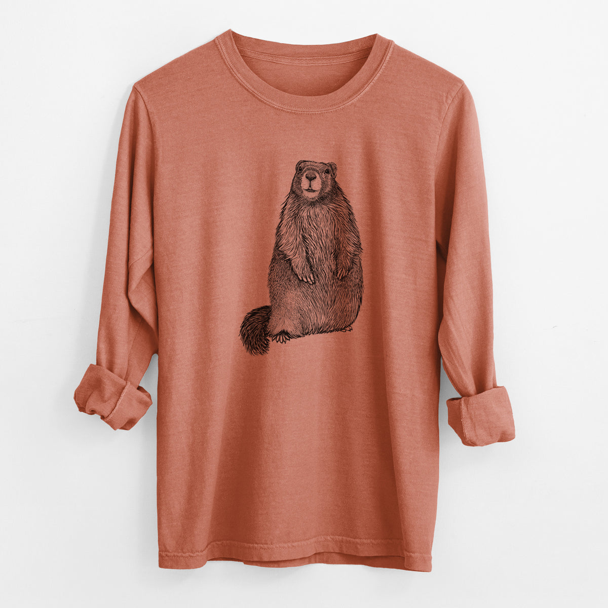 Yam burnt orange Comfort Colors long sleeve shirt laid flat with the cuffs rolled, printed with a detailed black ink illustration of a marmot standing upright.