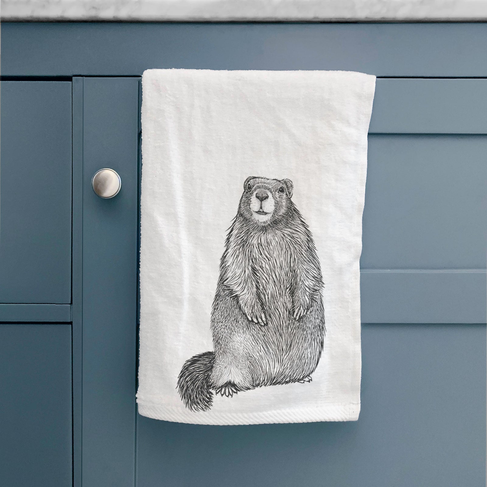 White hand towel printed with a detailed black ink illustration of a marmot standing upright.