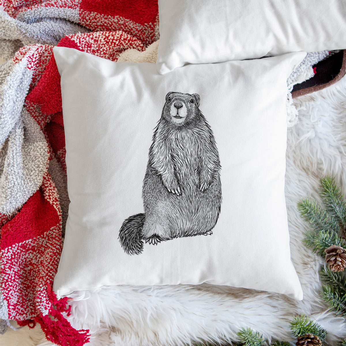 White pillow cover printed with a detailed black ink illustration of a marmot standing upright, on a woven chair.