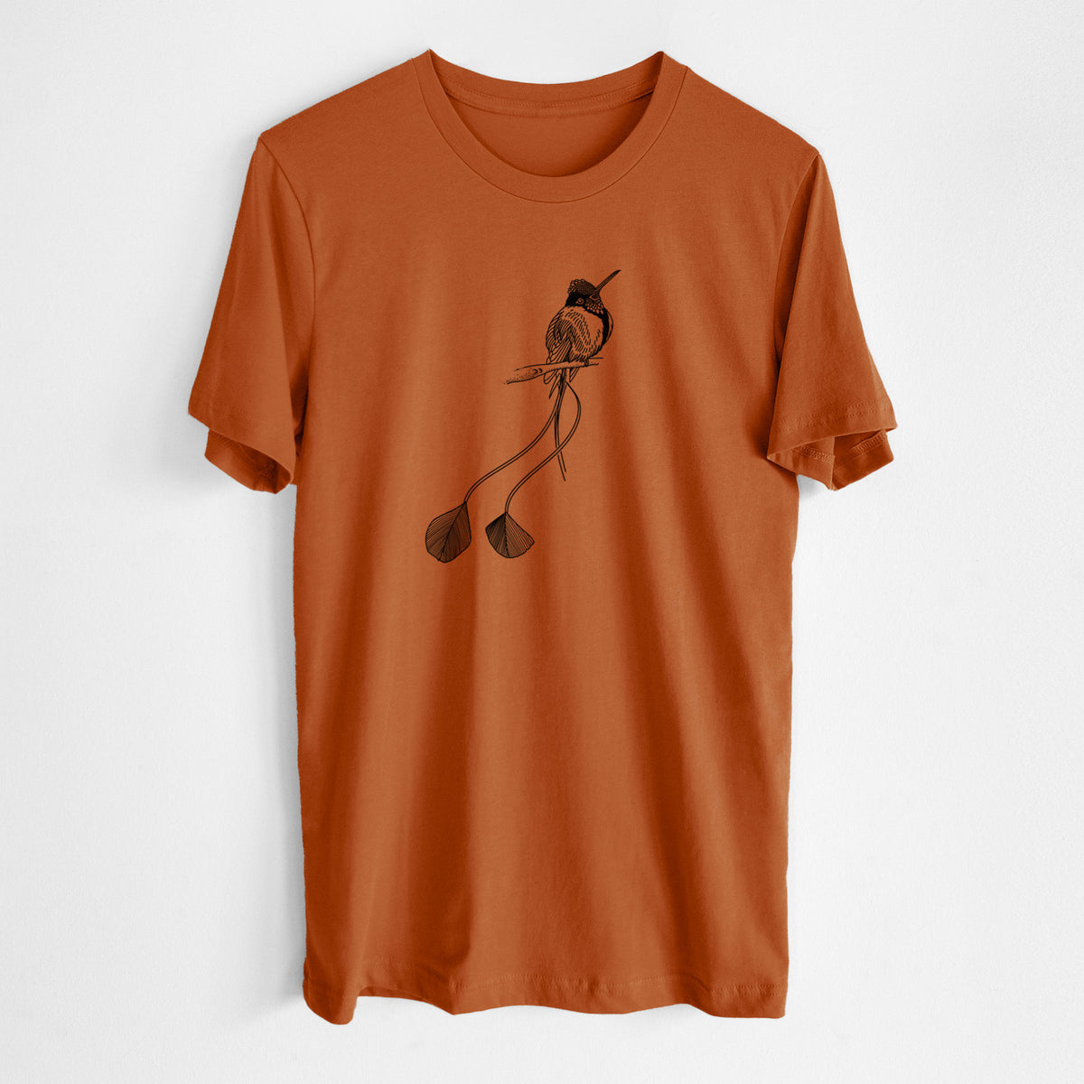 Autumn lightweight cotton t-shirt laid flat, printed with a black ink illustration of a marvelous spatuletail hummingbird perched, with its two long racket-tipped tail feathers.