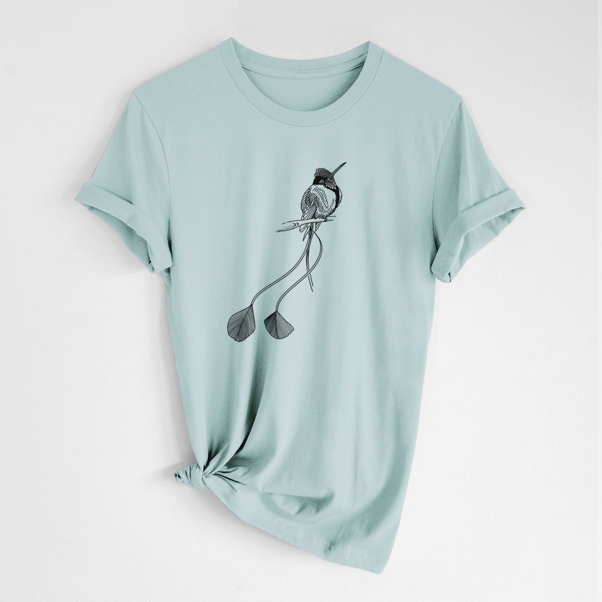 Dusty blue lightweight cotton t-shirt laid flat with the sleeves rolled, printed with a black ink illustration of a marvelous spatuletail hummingbird perched, with its two long racket-tipped tail feathers.
