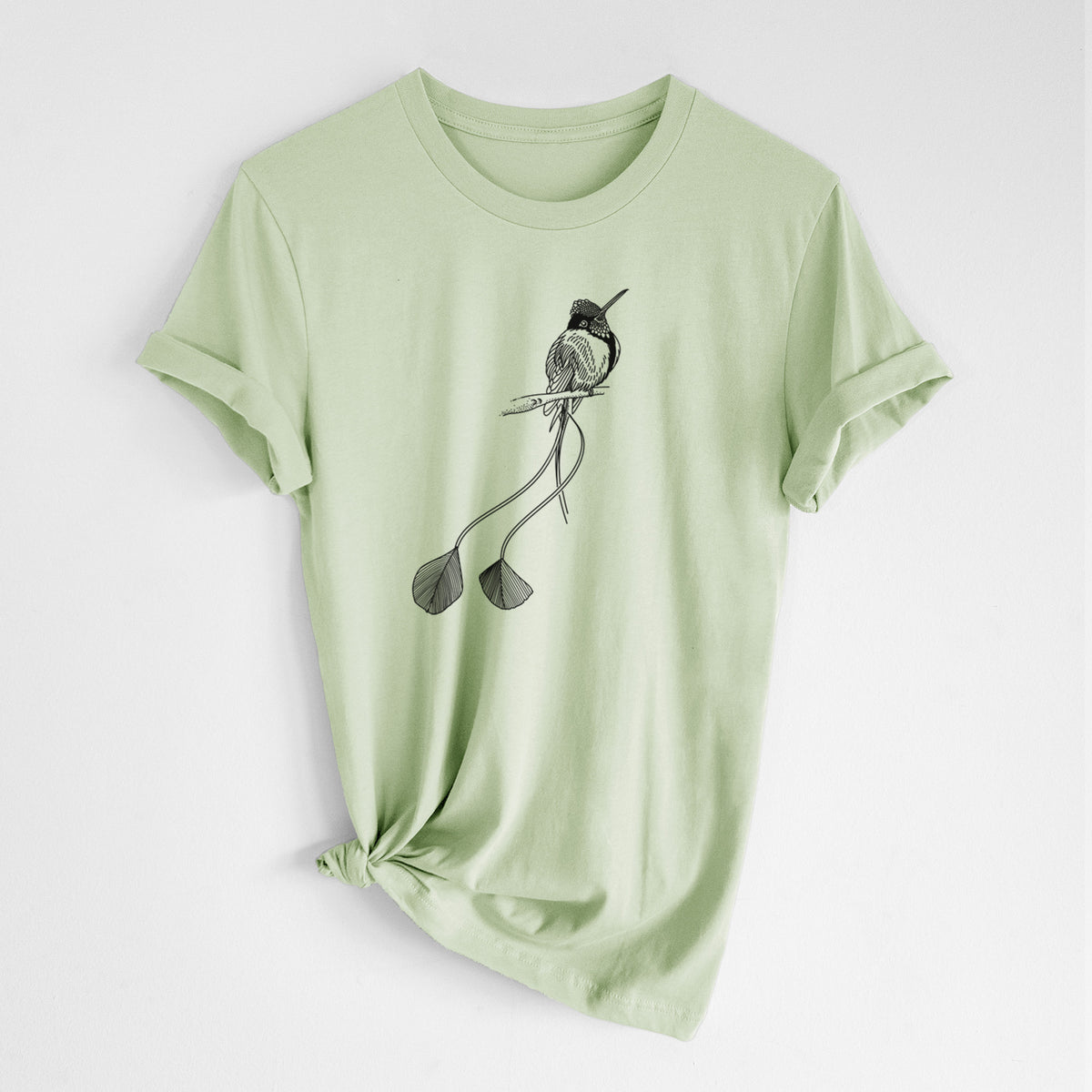 Spring green lightweight cotton t-shirt laid flat with the sleeves rolled, printed with a black ink illustration of a marvelous spatuletail hummingbird perched, with its two long racket-tipped tail feathers.