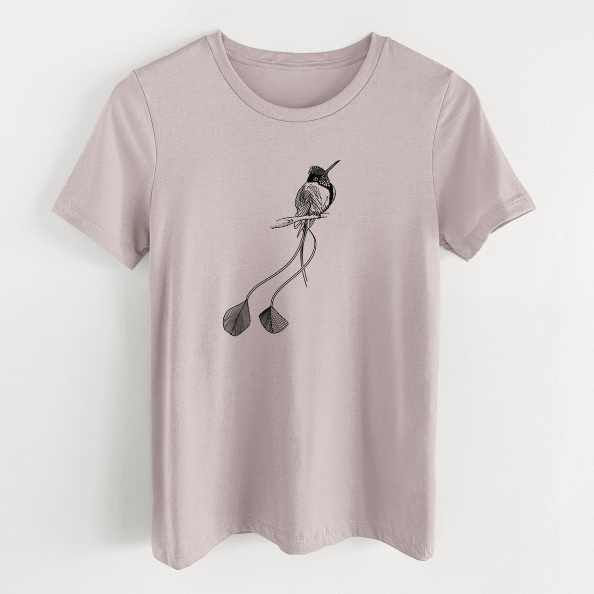 Pink gravel women's relaxed fit cotton t-shirt laid flat, printed with a black ink illustration of a marvelous spatuletail hummingbird perched, with its two long racket-tipped tail feathers.