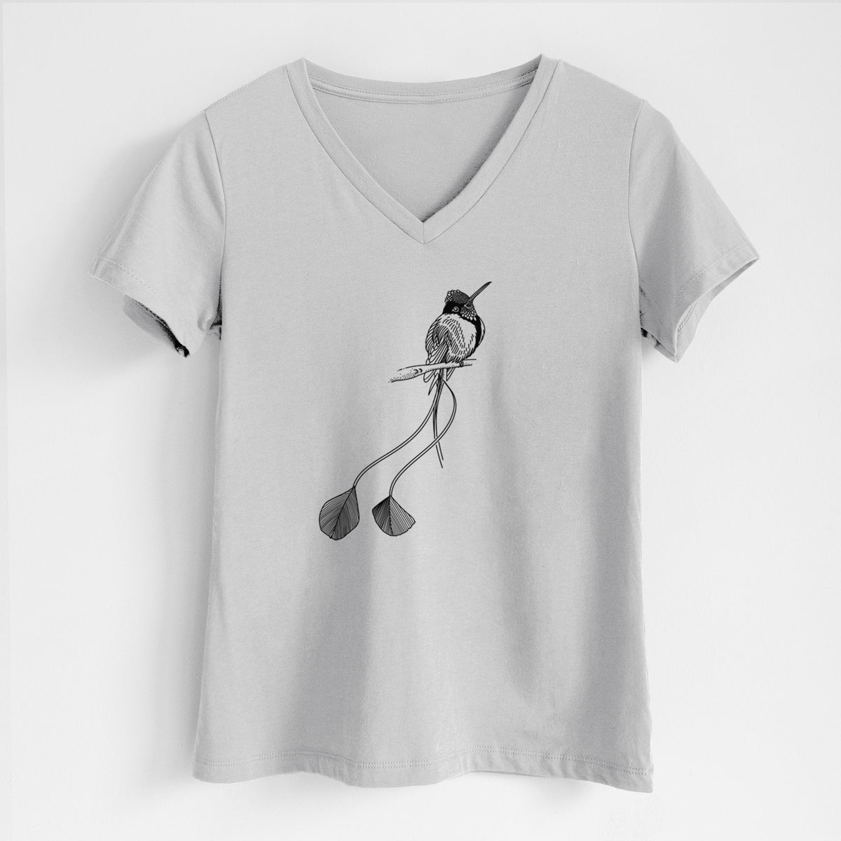 Lunar grey women's relaxed fit cotton V-neck t-shirt laid flat, printed with a black ink illustration of a marvelous spatuletail hummingbird perched, with its two long racket-tipped tail feathers.