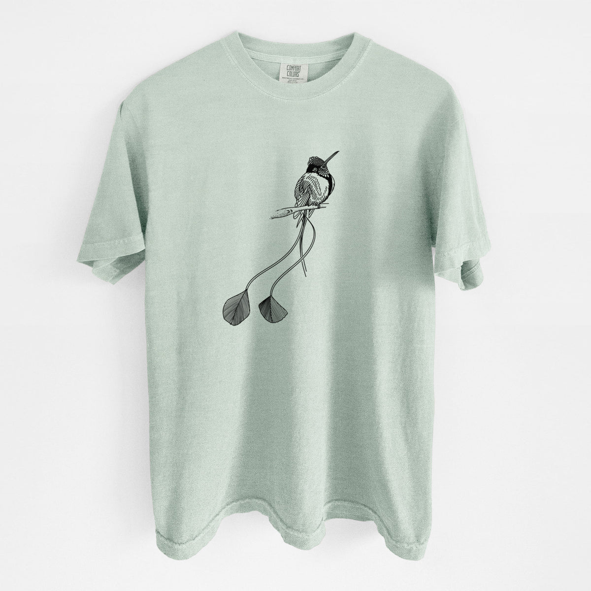 Bay green Comfort Colors t-shirt laid flat, printed with a black ink illustration of a marvelous spatuletail hummingbird perched, with its two long racket-tipped tail feathers.