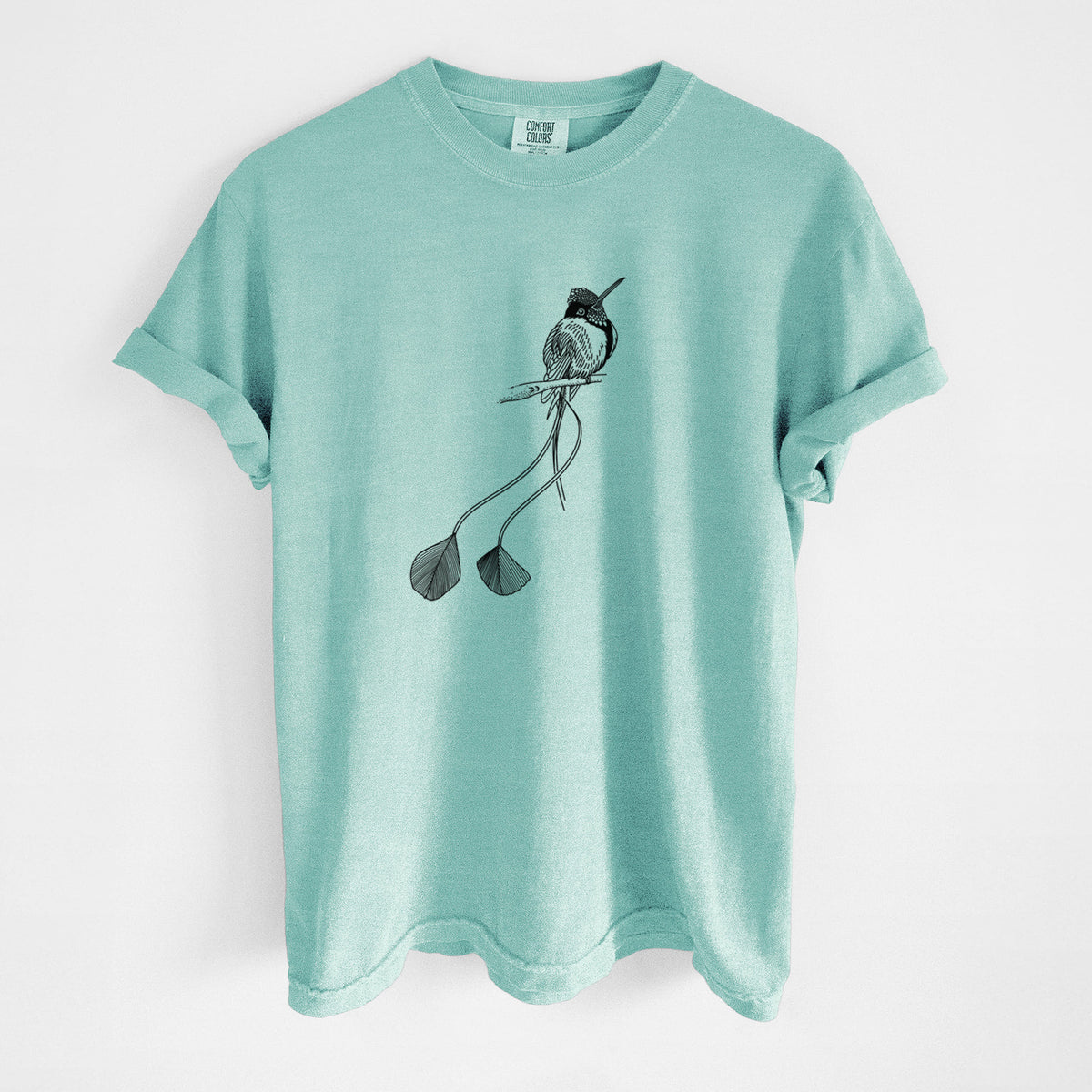 Chalky mint Comfort Colors t-shirt laid flat, printed with a black ink illustration of a marvelous spatuletail hummingbird perched, with its two long racket-tipped tail feathers.