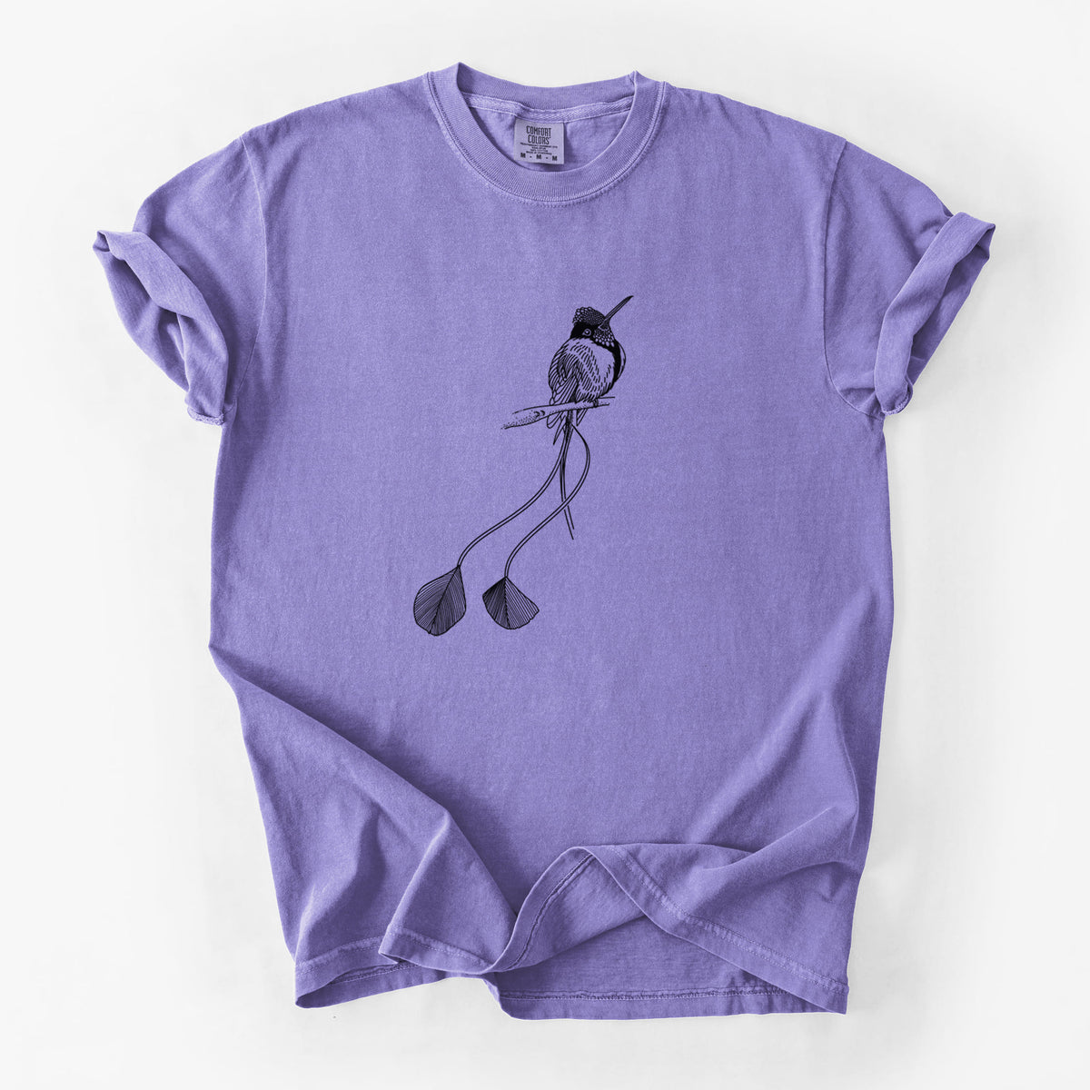 Violet purple Comfort Colors t-shirt laid flat, printed with a black ink illustration of a marvelous spatuletail hummingbird perched, with its two long racket-tipped tail feathers.