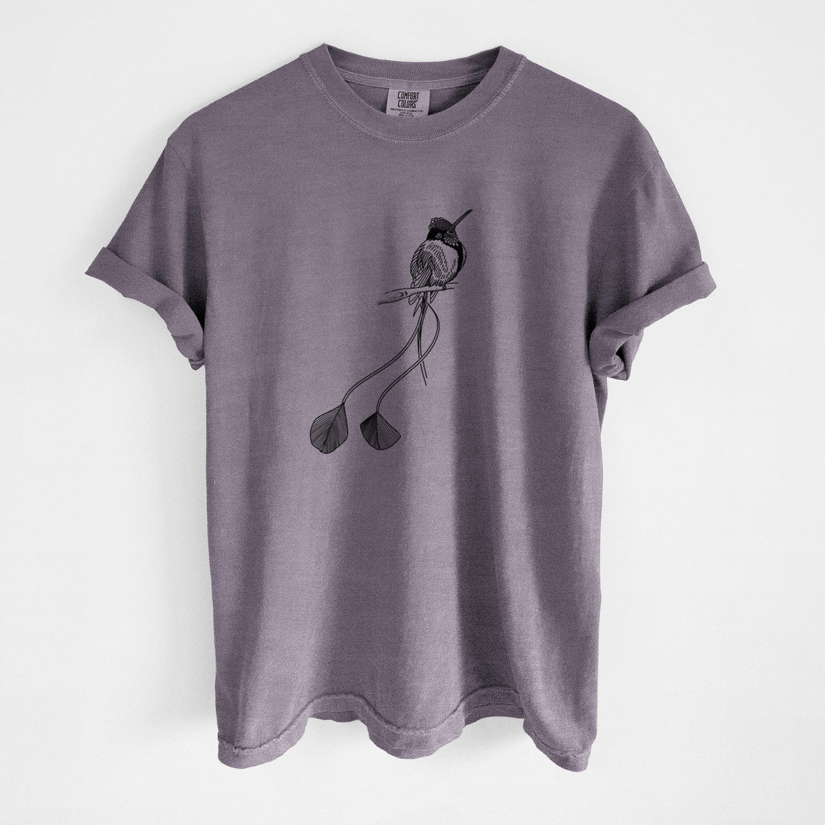 Wine red Comfort Colors t-shirt laid flat, printed with a black ink illustration of a marvelous spatuletail hummingbird perched, with its two long racket-tipped tail feathers.