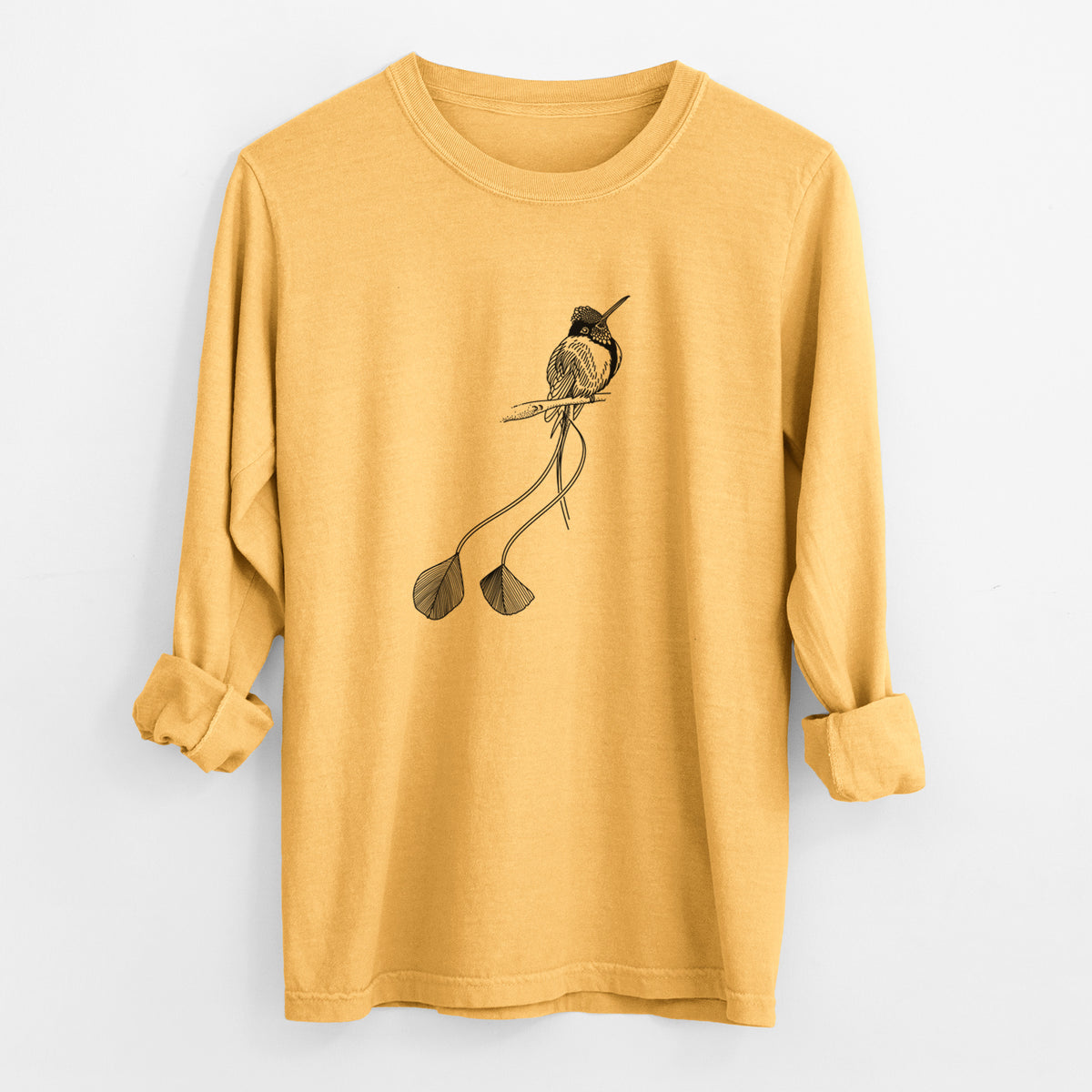 Golden wheat yellow Comfort Colors long sleeve shirt laid flat with the cuffs rolled, printed with a black ink illustration of a marvelous spatuletail hummingbird perched, with its two long racket-tipped tail feathers.