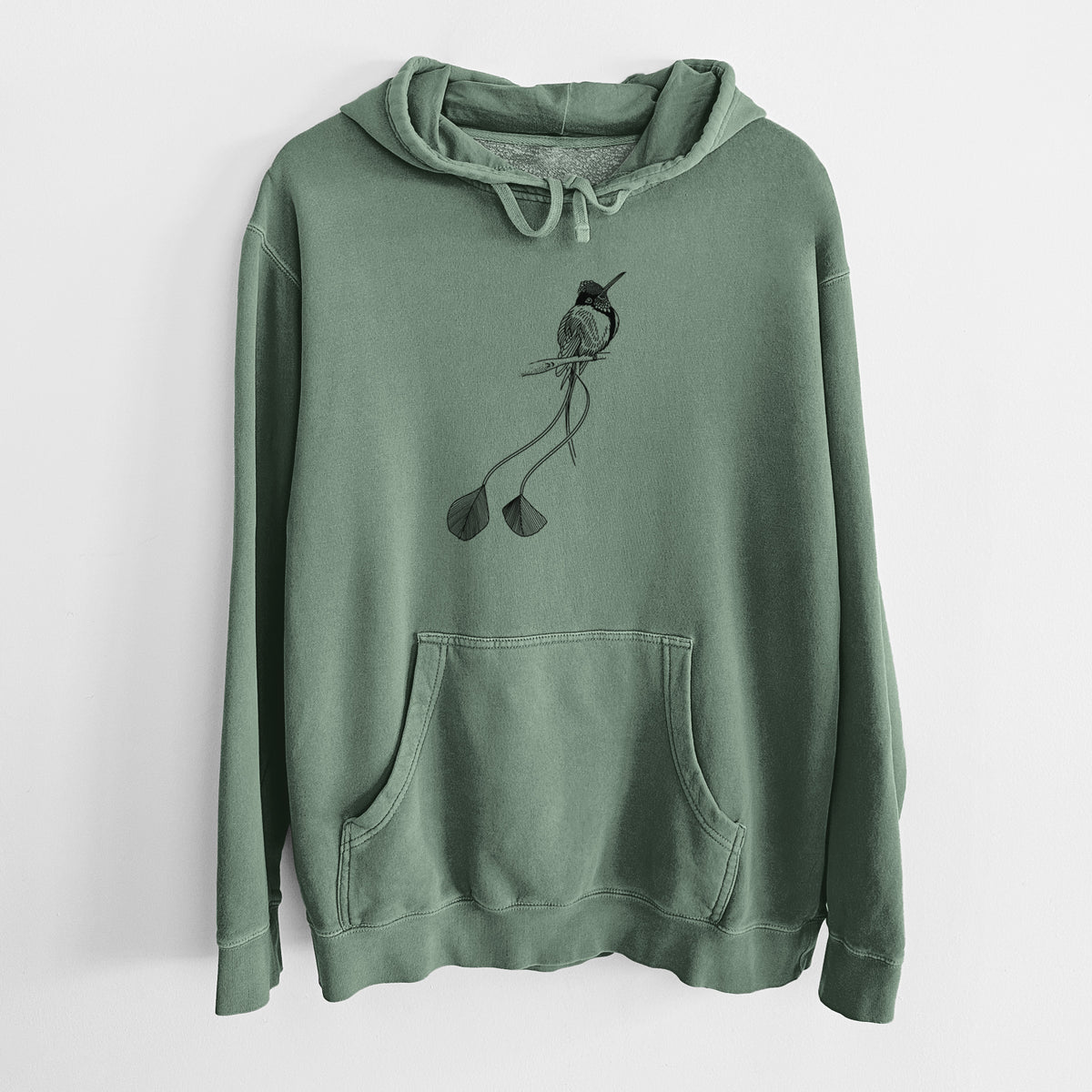 Alpine green pigment dyed hoodie laid flat, printed with a black ink illustration of a marvelous spatuletail hummingbird perched, with its two long racket-tipped tail feathers.