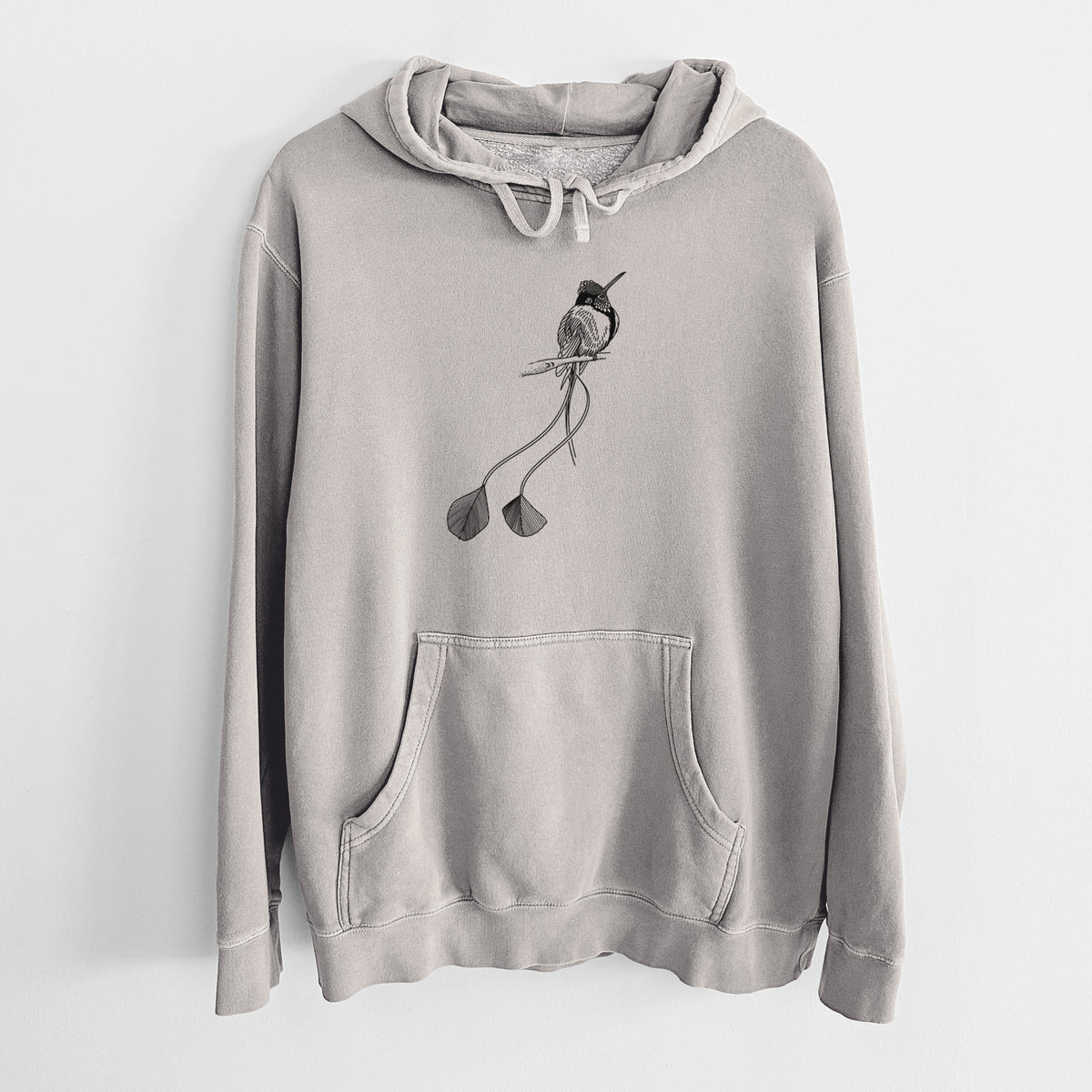 Cement grey pigment dyed hoodie laid flat, printed with a black ink illustration of a marvelous spatuletail hummingbird perched, with its two long racket-tipped tail feathers.