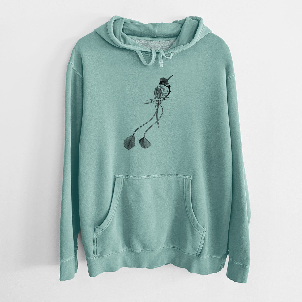 Mint green pigment dyed hoodie laid flat, printed with a black ink illustration of a marvelous spatuletail hummingbird perched, with its two long racket-tipped tail feathers.
