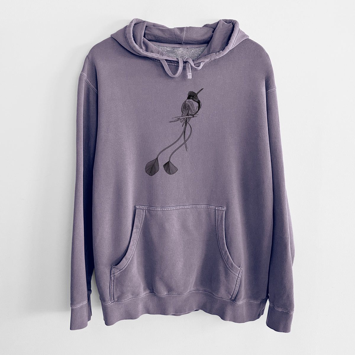 Plum purple pigment dyed hoodie laid flat, printed with a black ink illustration of a marvelous spatuletail hummingbird perched, with its two long racket-tipped tail feathers.